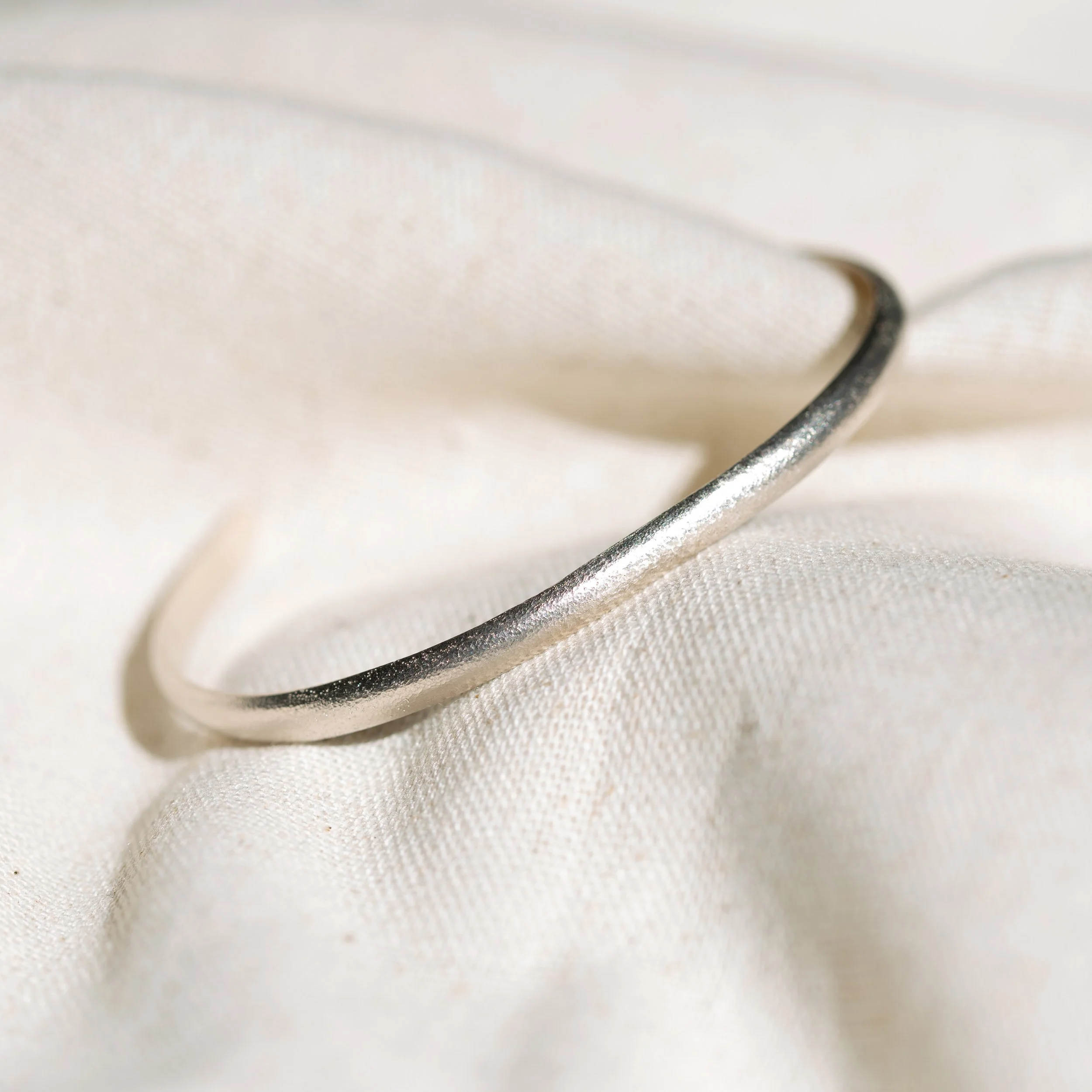 PF019

The nineteenth piece.

A single length of AgPd, drawn into a restrained open cuff and finished with a softly worked surface that catches light without asking for it.

No stone. No ornament. Nothing to distract from line, weight, and metal.

Qu