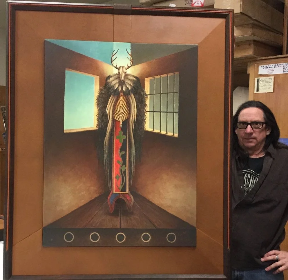 Randy Berger stands with a leather frame he created for Joe Geshick's piece titled SELF PORTRAIT