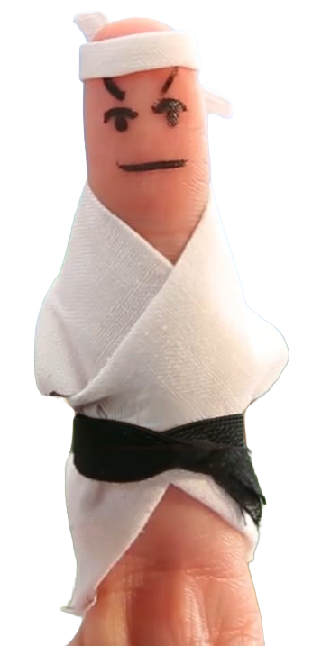 Fingertip decorated to look like a martial artist wearing a white karate gi and black belt, with a face drawn on top, capturing a humorous puppet-like character.