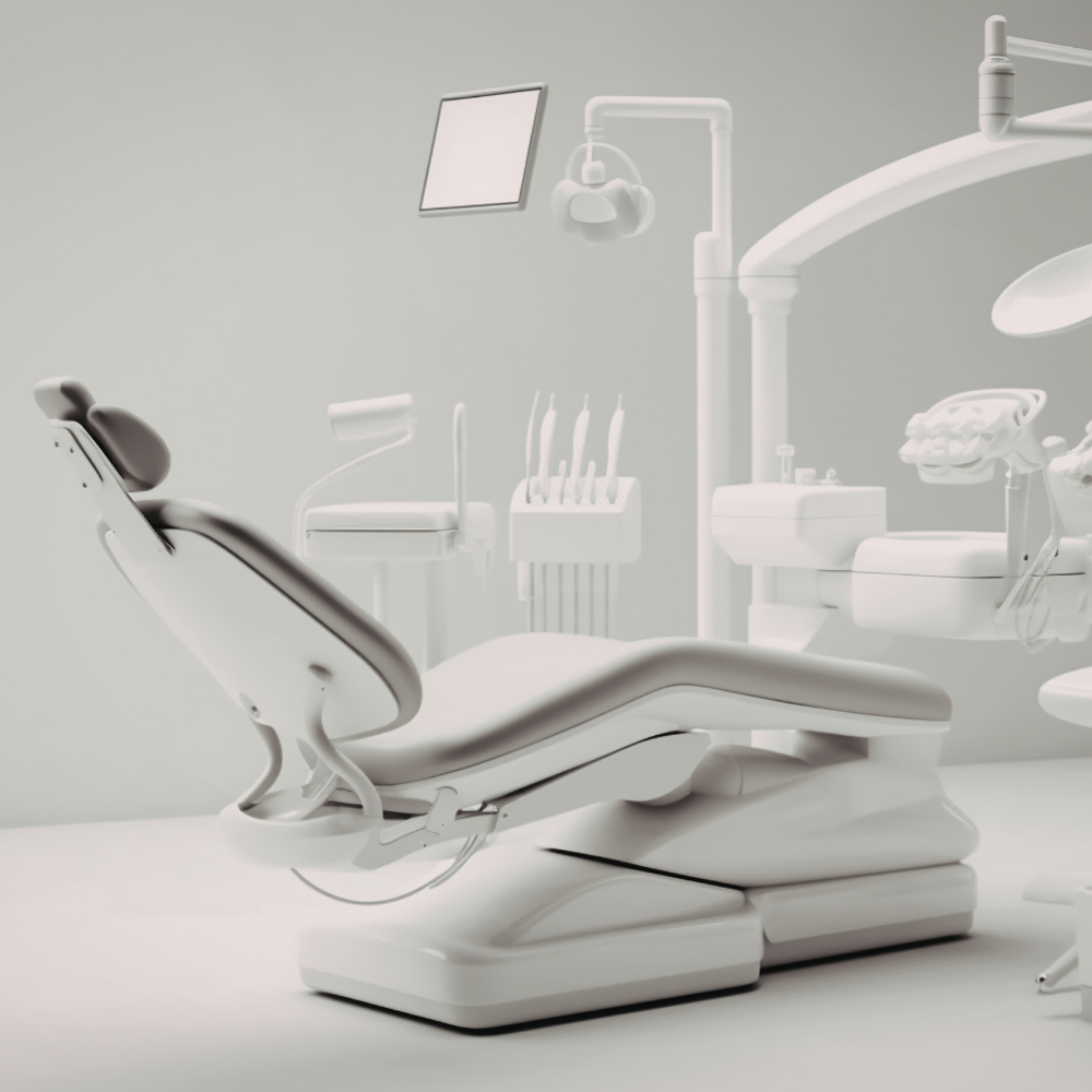 Empty dental office with dental chair, overhead light, and dental tools.