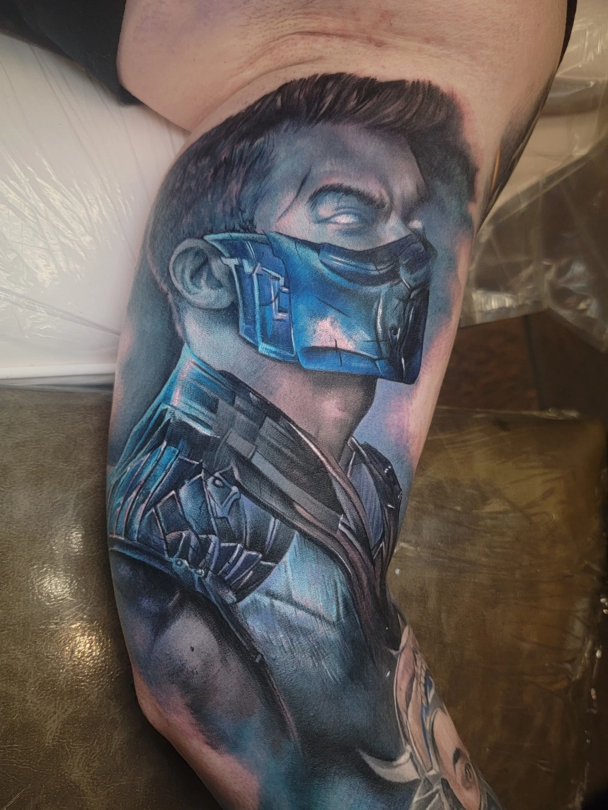A detailed tattoo of a video game character on a person's inner arm