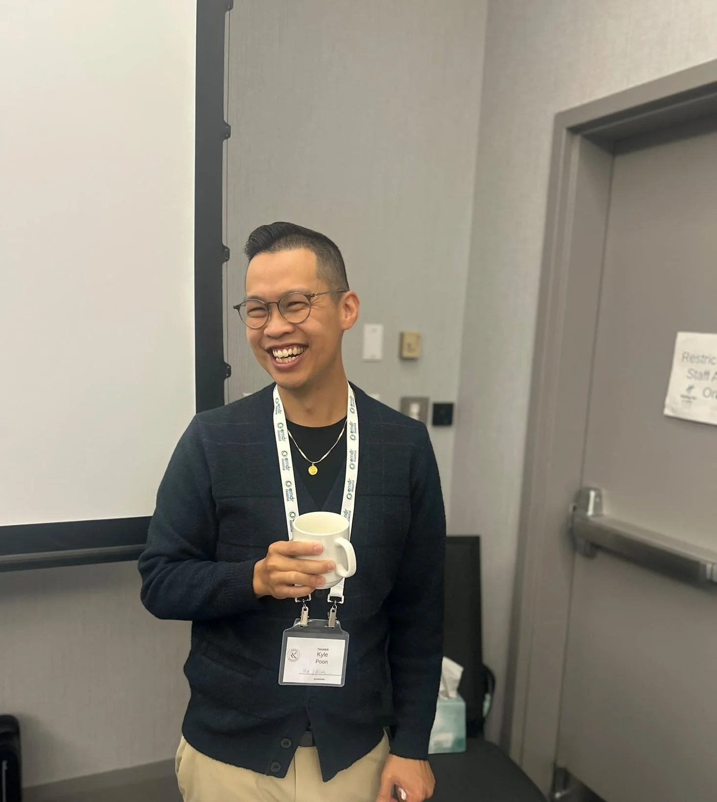Kyle Poon, R.Psych, smiling during a break at an EMDR Basic Training
