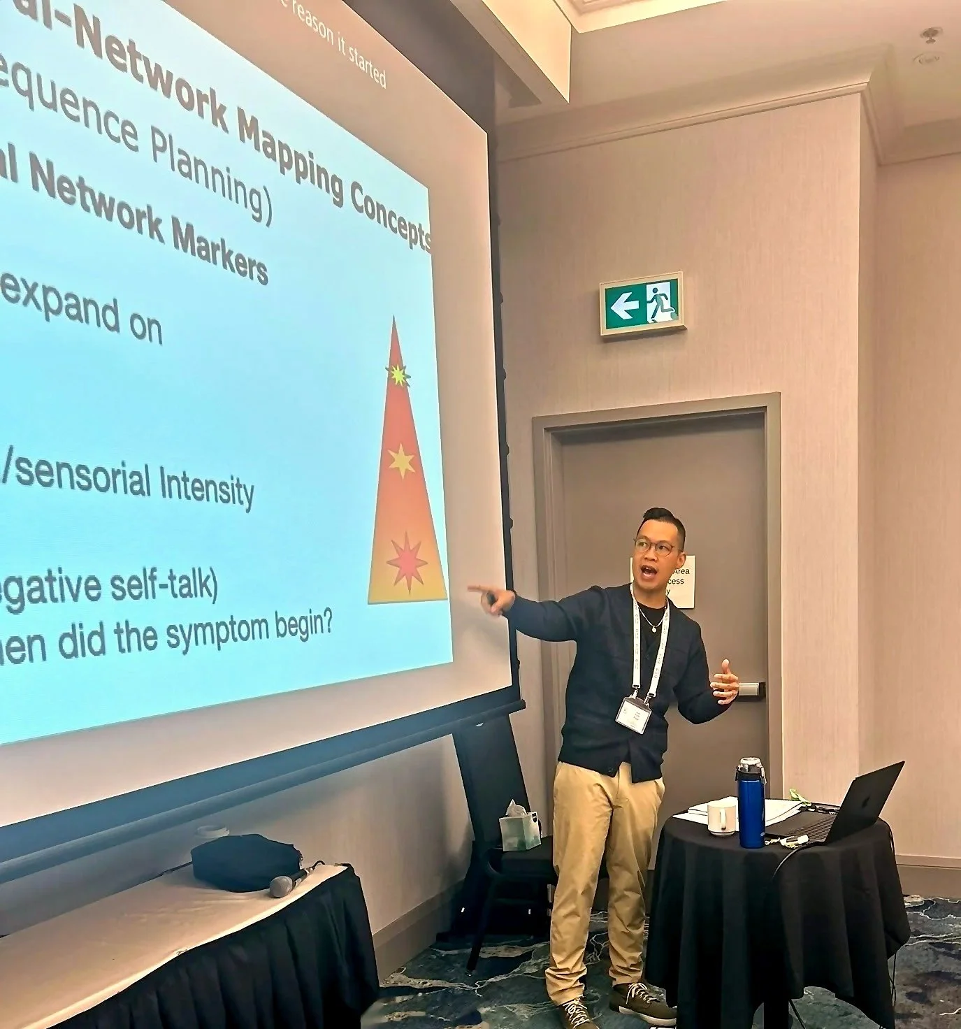 Kyle Poon presenting a slide on network mapping and target sequence planning in EMDR