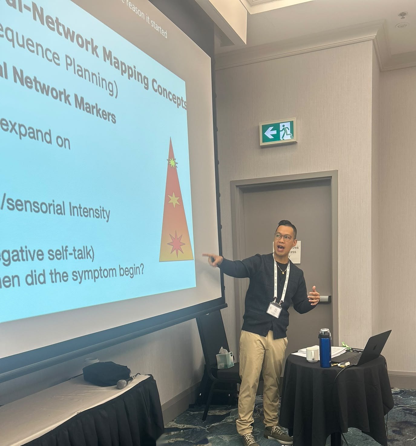 Kyle Poon presenting a slide on network mapping and target sequence planning in EMDR