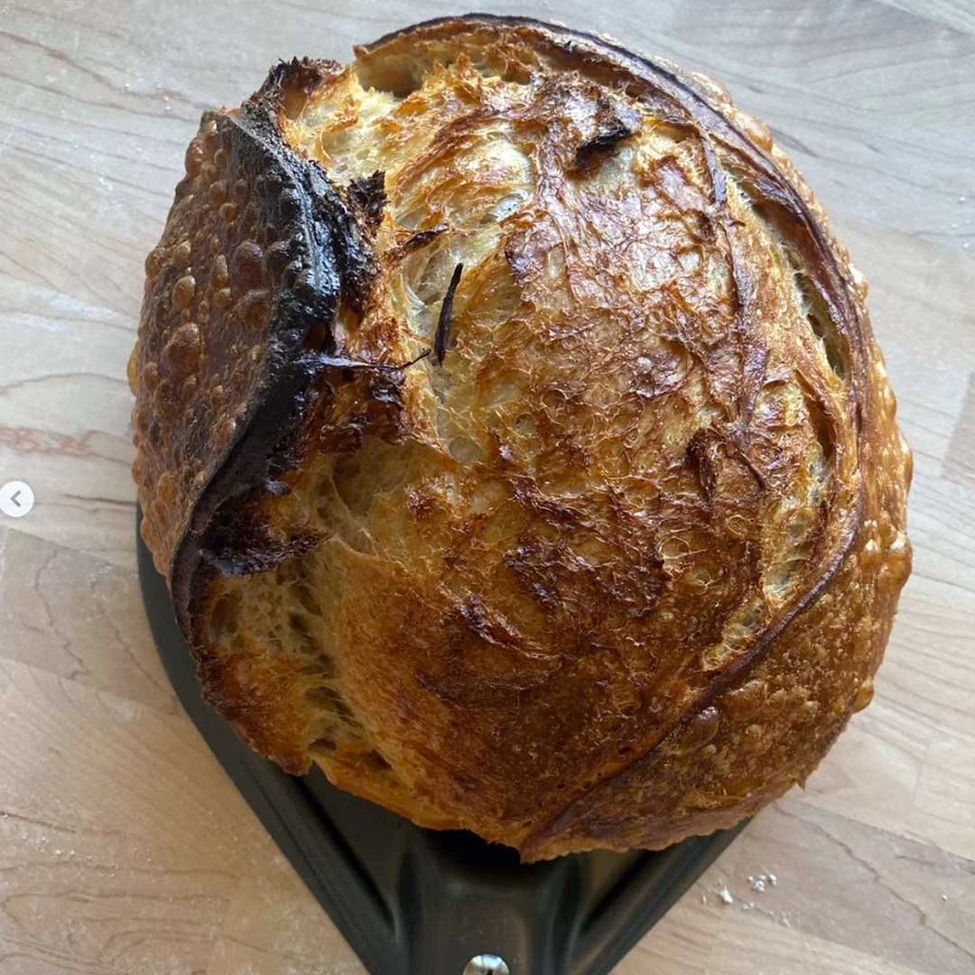 Round loaf of brown sourdough bread