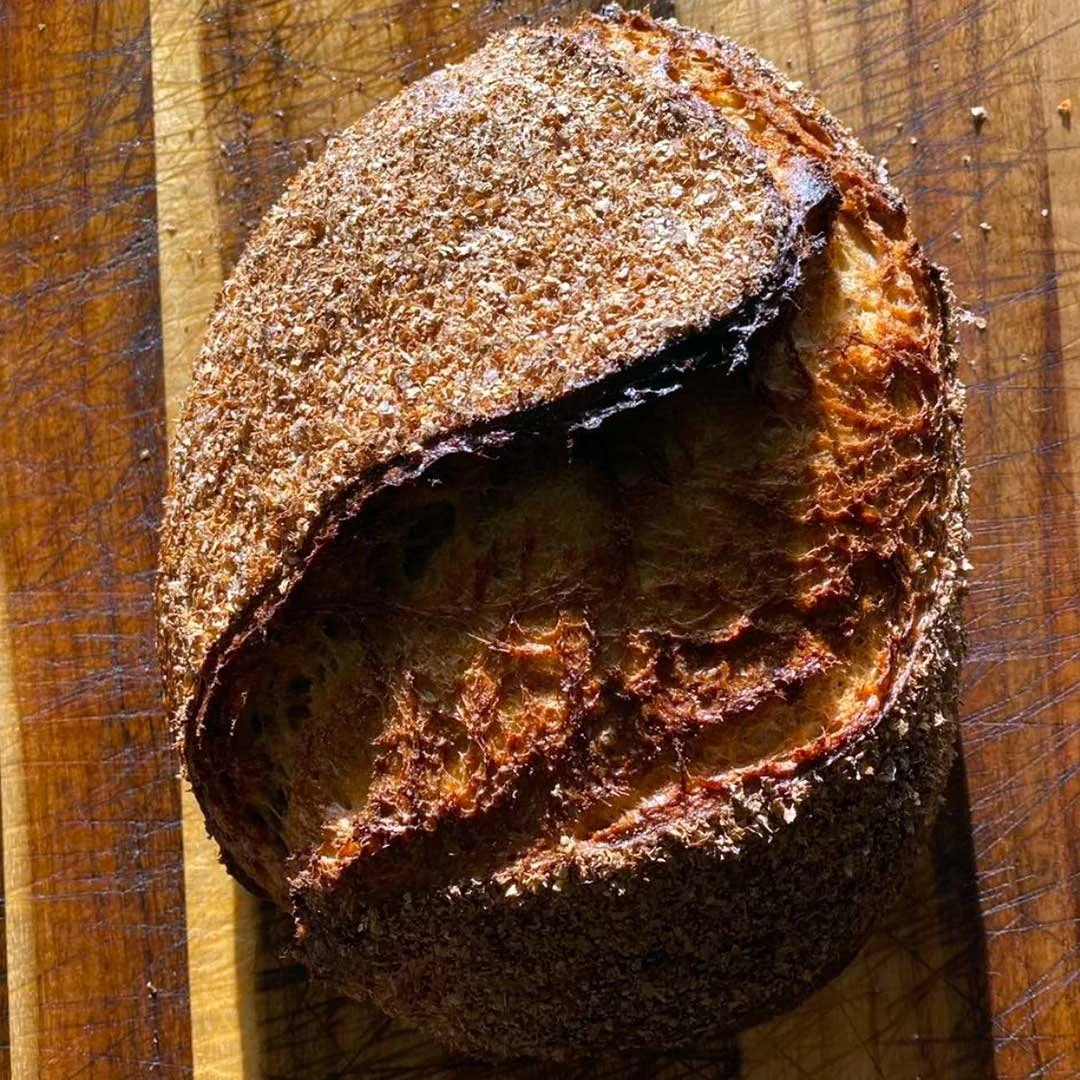 Wheat sourdough loaf on wooden background