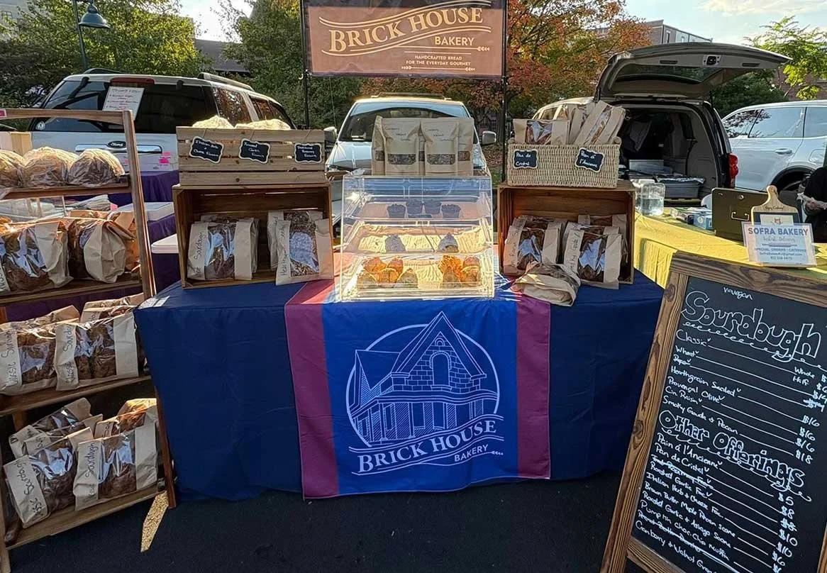 Market stand at the farmers market with sourdough bread and other baked goods