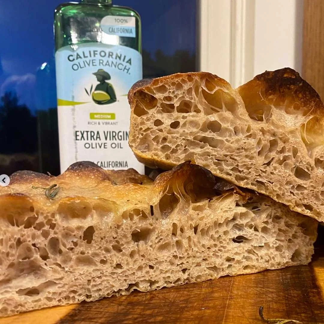 Focaccia is what got us into bread. We couldn't find good focaccia in town — so we made it. Fluffy, airy, never greasy. Customers call it "healthy addicting" and tear it from the bag.