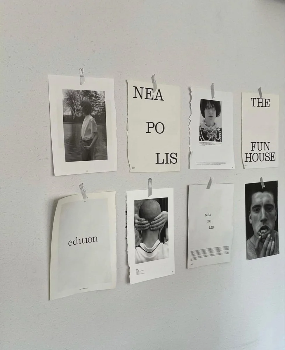 Photos, text, and illustrations on a wall with images of people and a cover page of a publication titled 'edition'.
