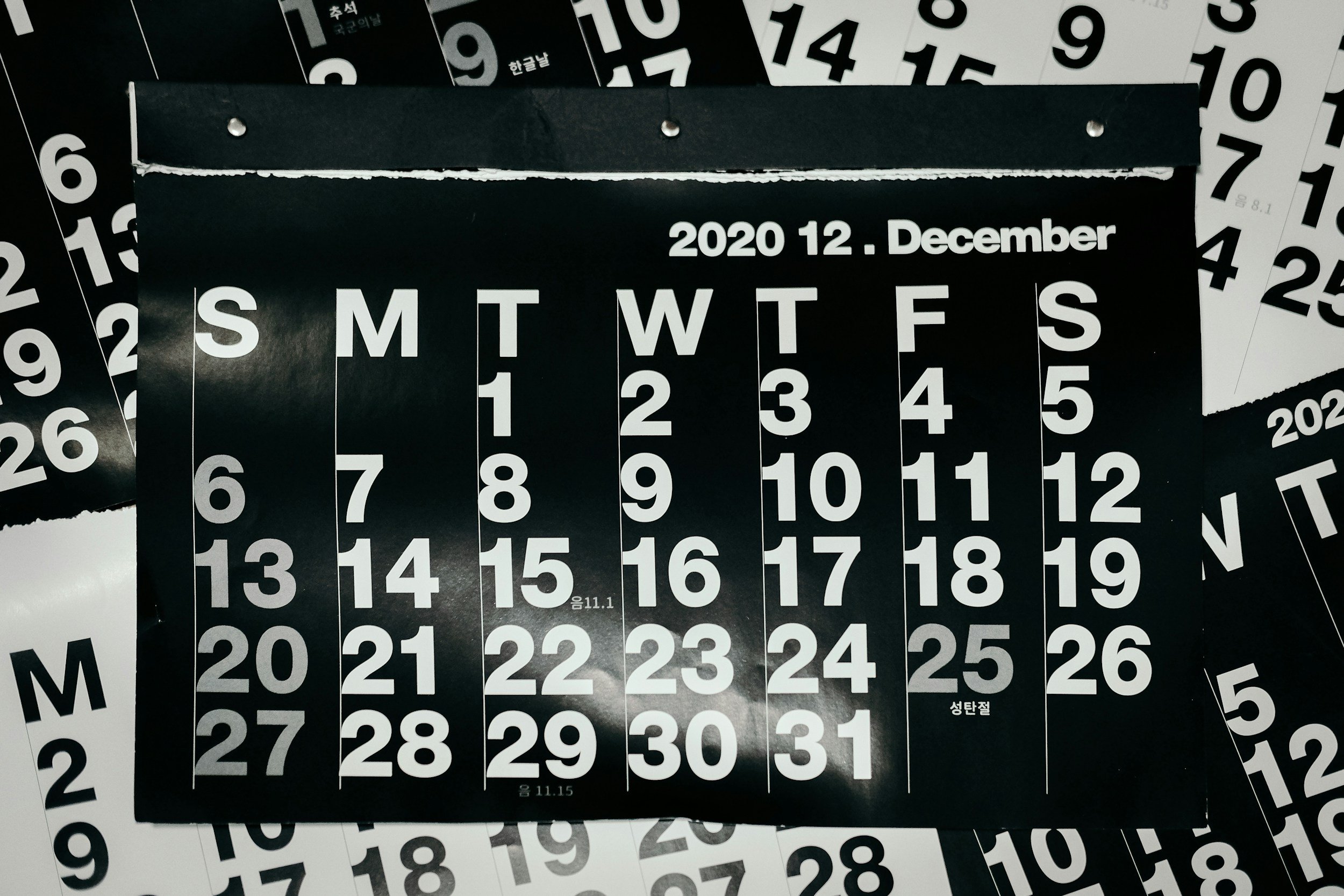 Stacked black and white calendar with dates and days of the week visible, offering a marketing discovery call with Summer Carrick Creative Marketing.