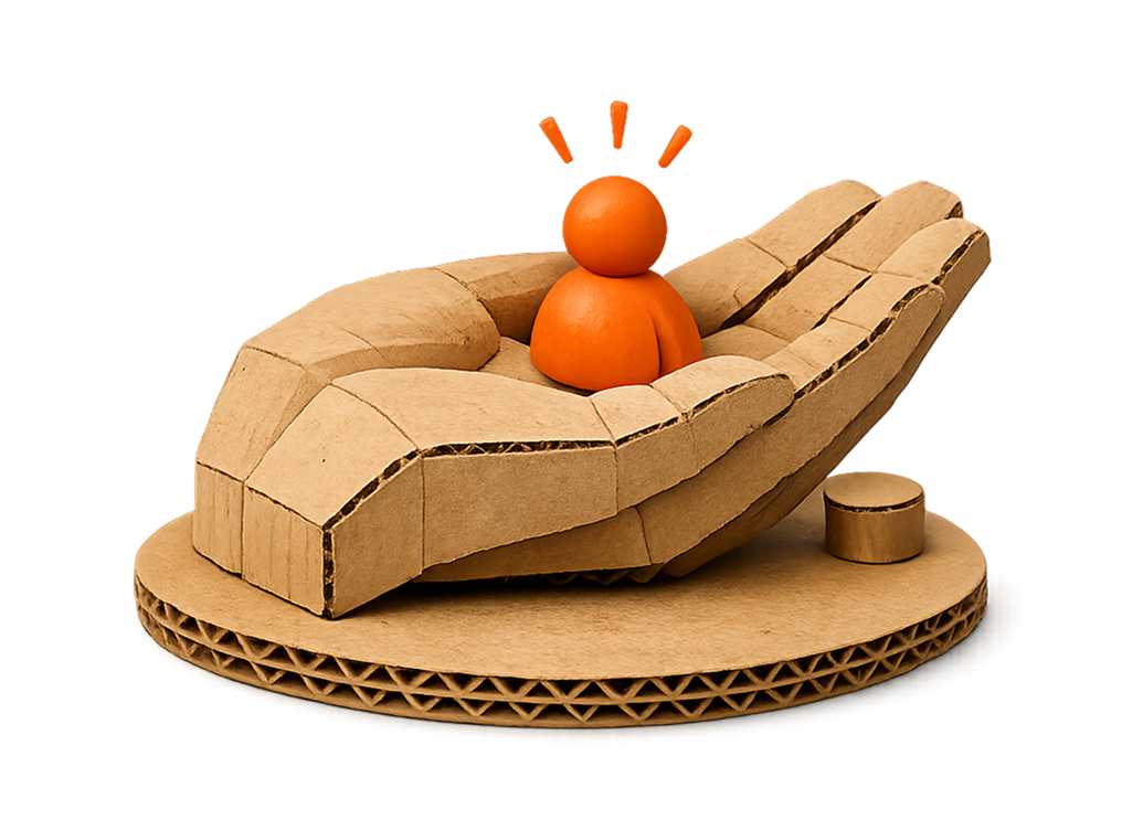 A cardboard modeled rocket with a small orange pumpkin in the middle, resembling a person, on a round cardboard base.