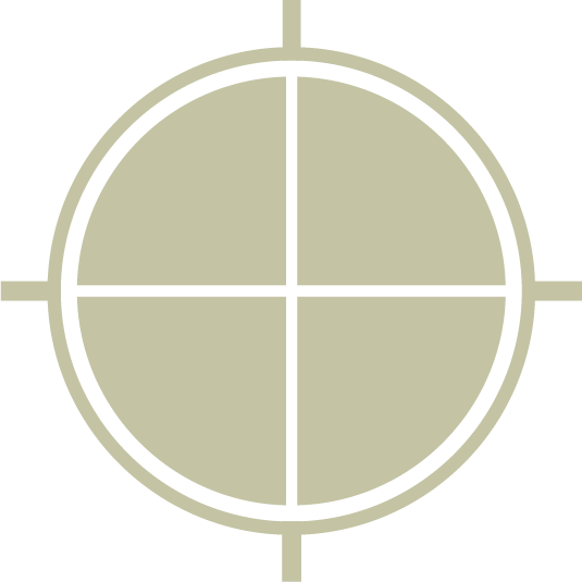 Close-up of a circular military or tactical target reticle with four quadrants and crosshairs.