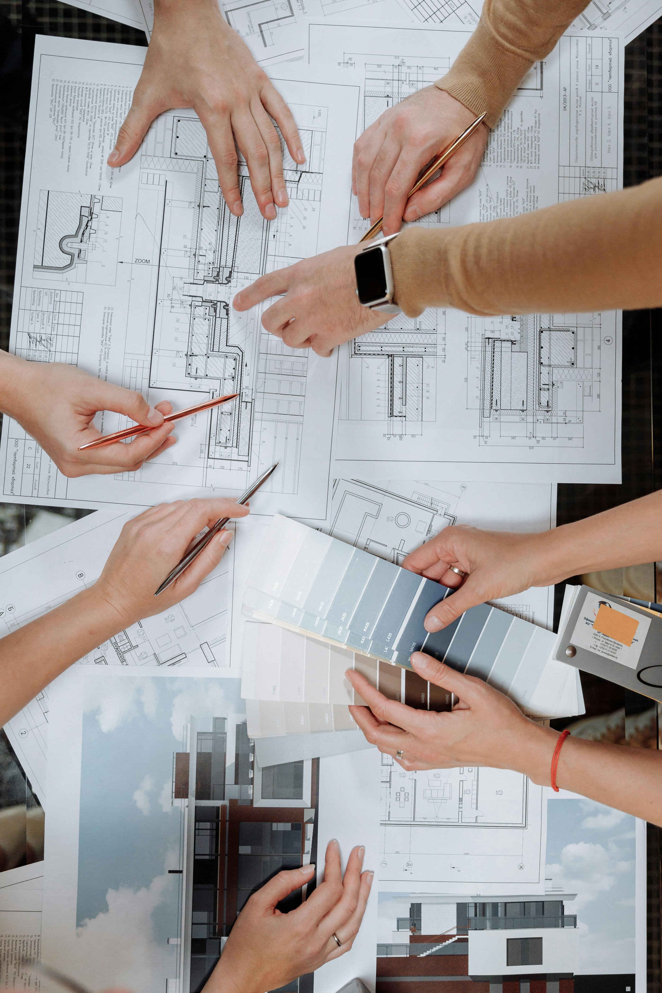 Draftsmen working on blueprints. We offer affordable residential design services in Idaho, including cities such as Boise, Meridian, Eagle, Kuna, McCall, Cascade, Caldwell, Melba, Middleton, Star, Horseshoe Bend, Emmett, and Marsing.