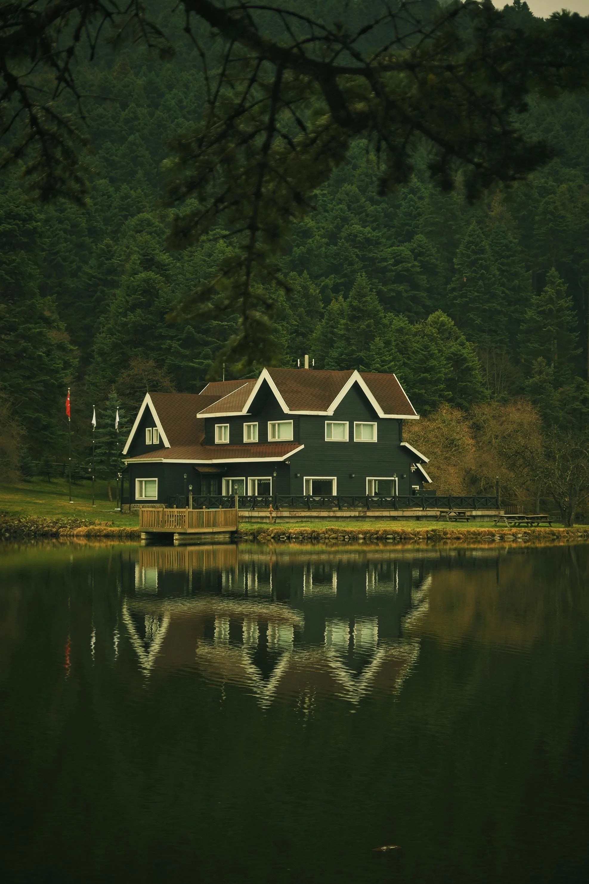 A large house by a lake. We offer affordable residential design services in Idaho, including cities such as Boise, Meridian, Eagle, Kuna, McCall, Cascade, Caldwell, Melba, Middleton, Star, Horseshoe Bend, Emmett, and Marsing.