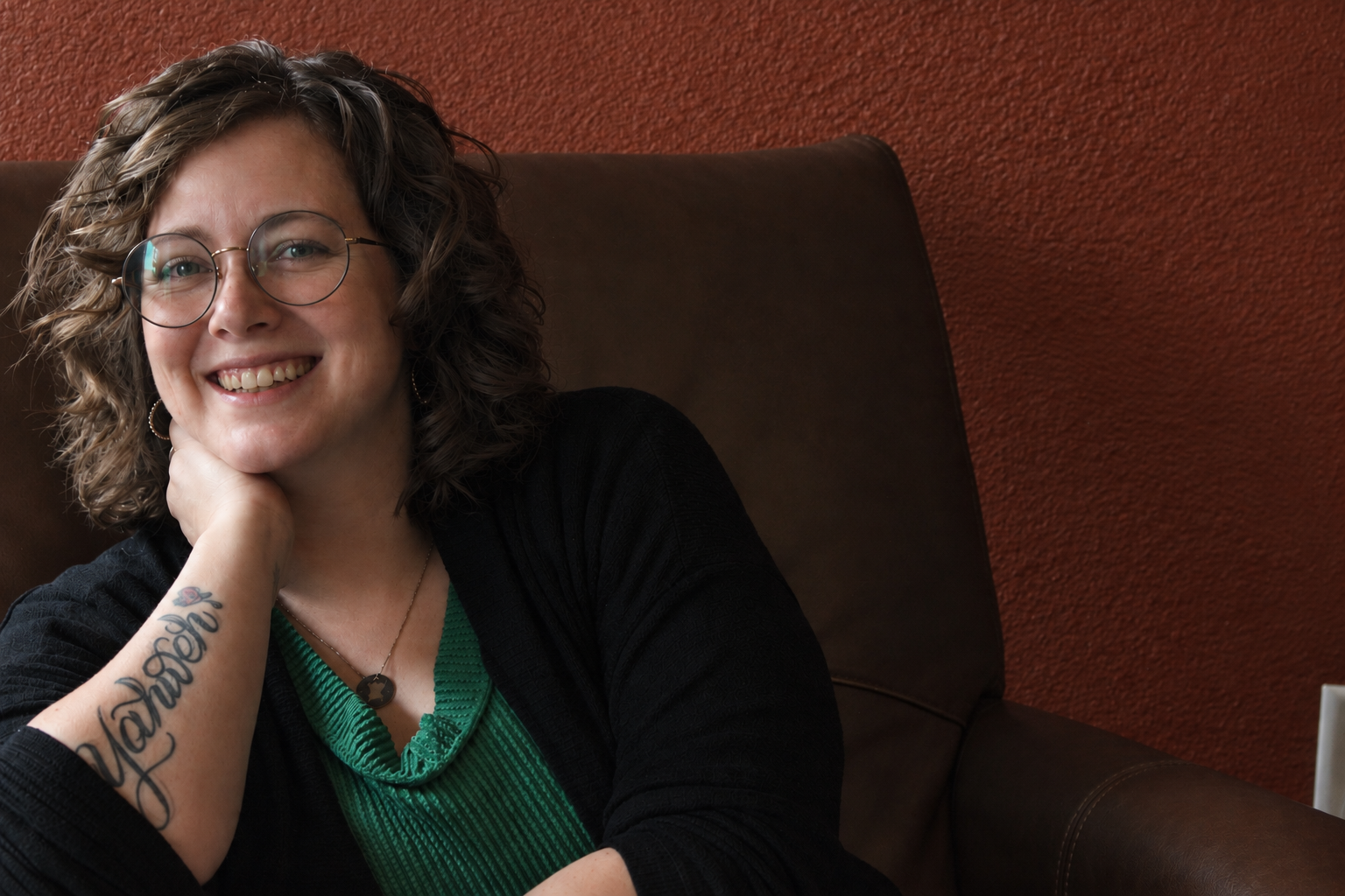 Kalli Stout smiling in a cozy counseling space