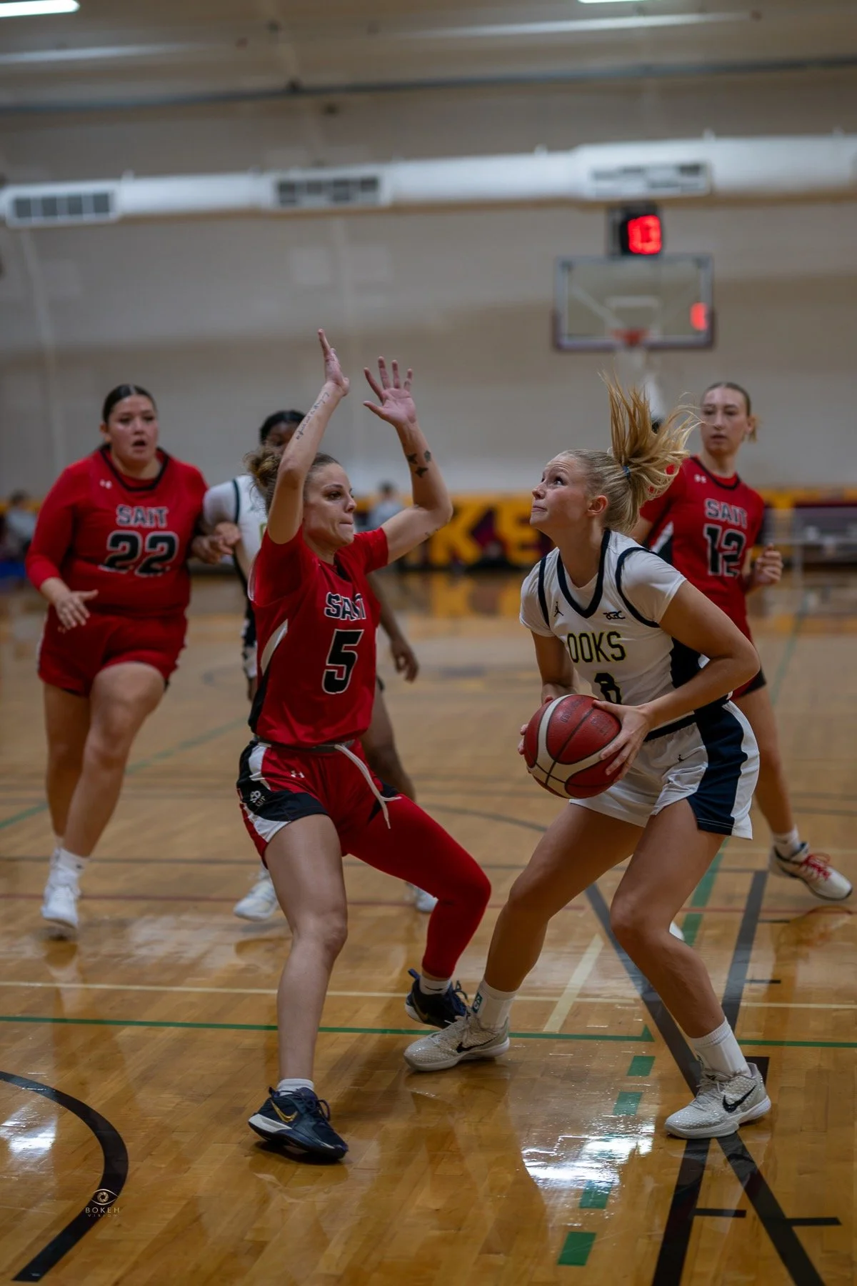 Basketball players driving through traffic during a competitive game
