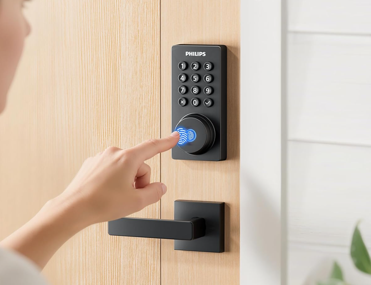 Person using a fingerprint scanner to unlock a door with a digital keypad lock, smart lock, smart deadbolt.