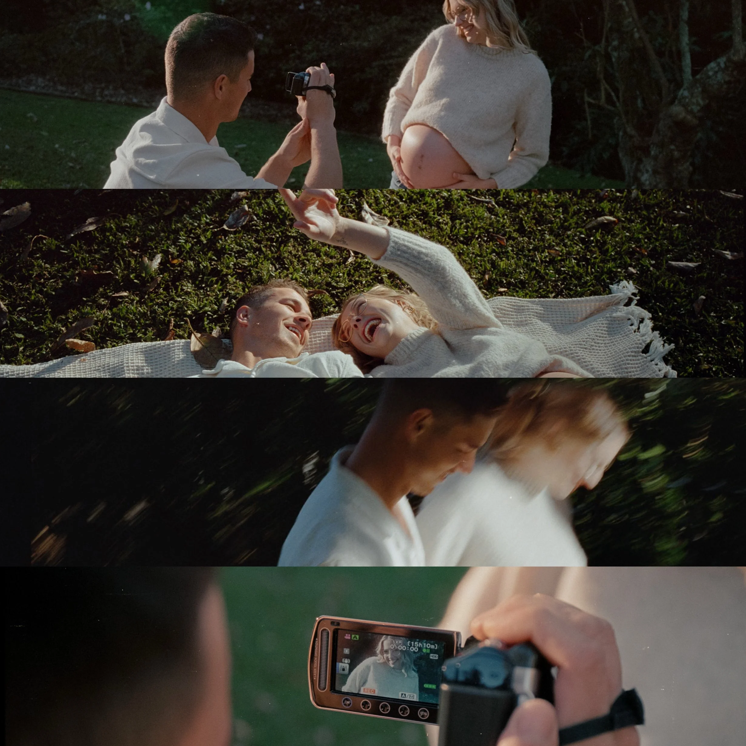 A couple is lying on the grass outdoors, smiling and holding hands. The man and woman are looking at each other, and the woman is visibly pregnant. The scene is captured through a camera held by another person, whose fingers and a smartphone recording the scene are visible in the foreground.