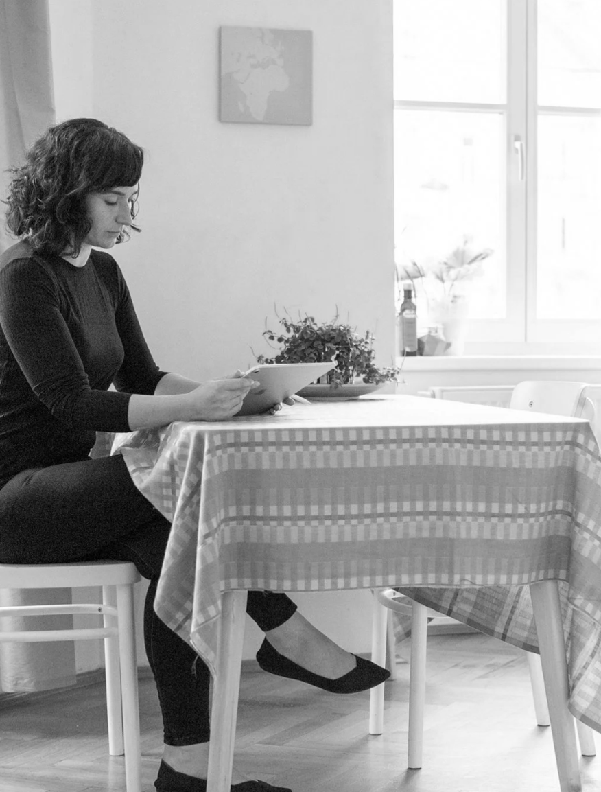 Image of Sara sitting at a desk