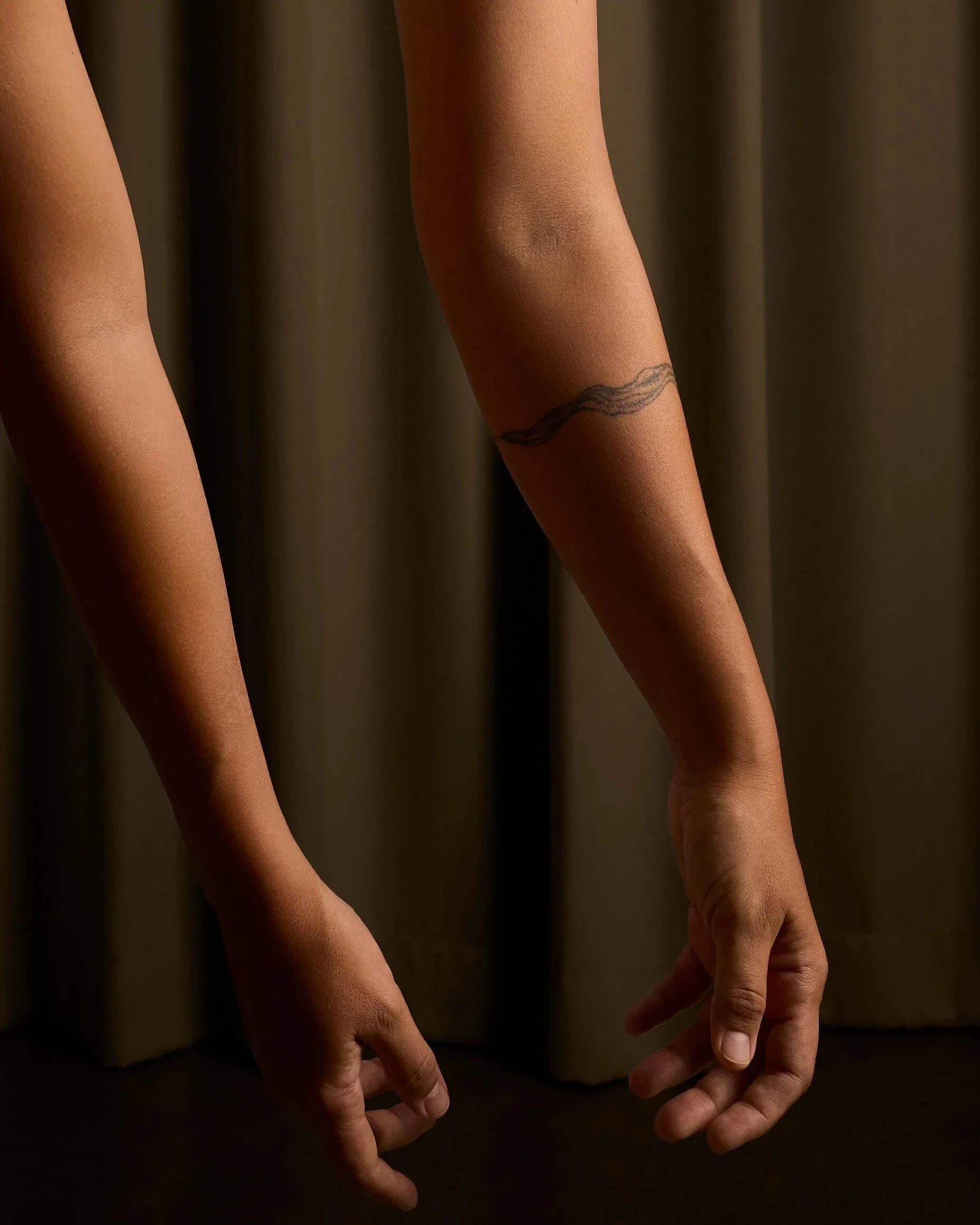 Two arms hanging loosely away from the body symbolizing how breathwork may help alleviate stress and tension in the body.