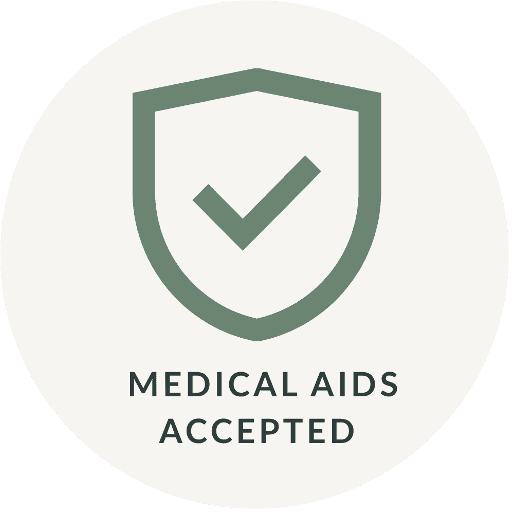 A round logo with a shield and a check mark inside, and the text "Medical Aids Accepted" below.