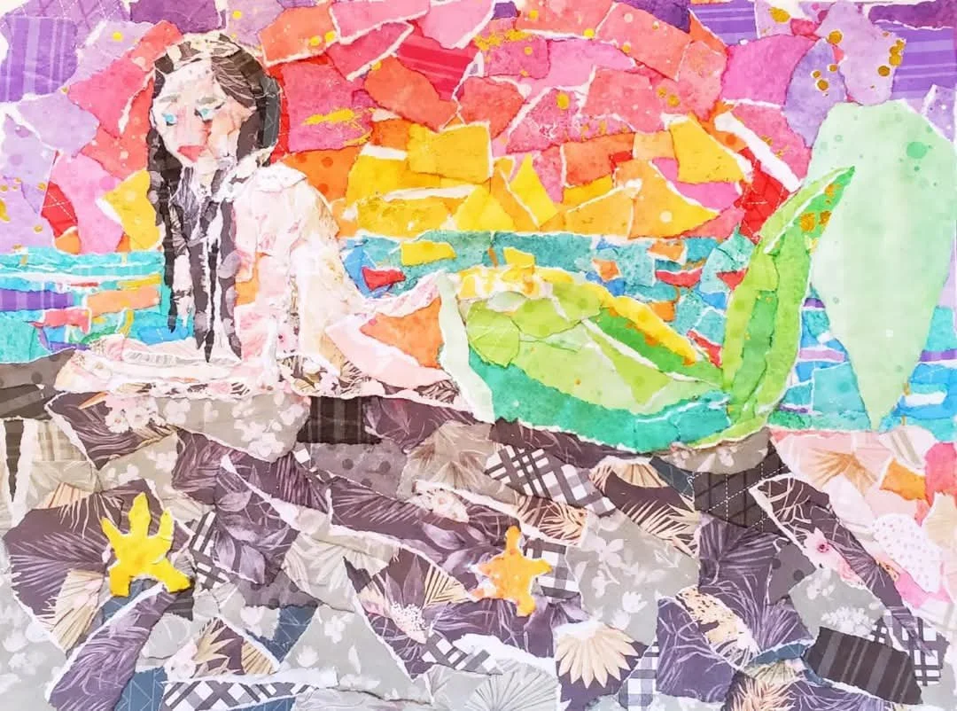 A colorful collage-style artwork depicting a person with pig tails sitting on the ground near a body of water, surrounded by vibrant, torn pieces of paper in various colors.
