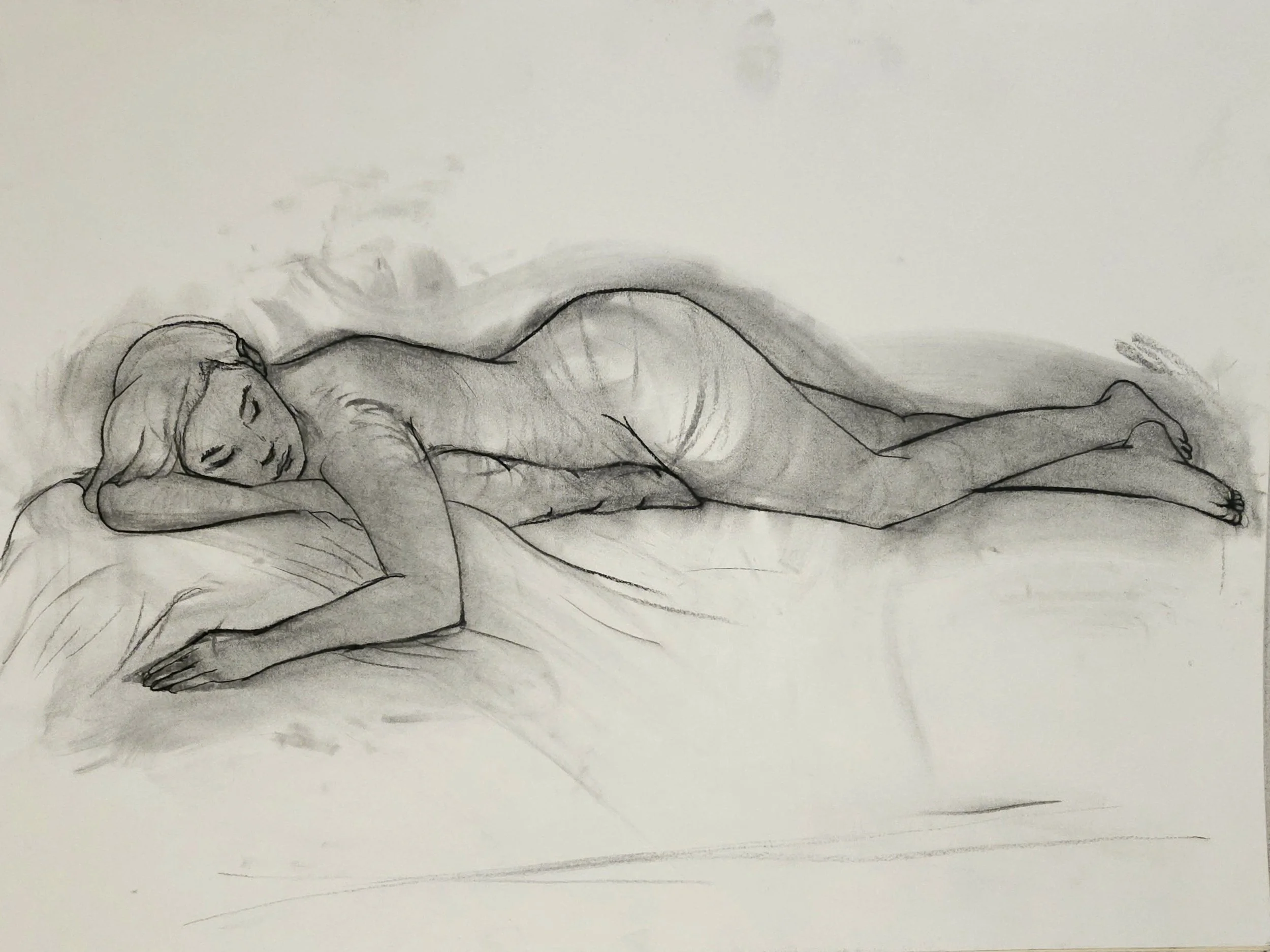 A sketch of a woman lying on her side, resting her head on her arm, with long hair and closed eyes, drawn with simple black lines on white paper.