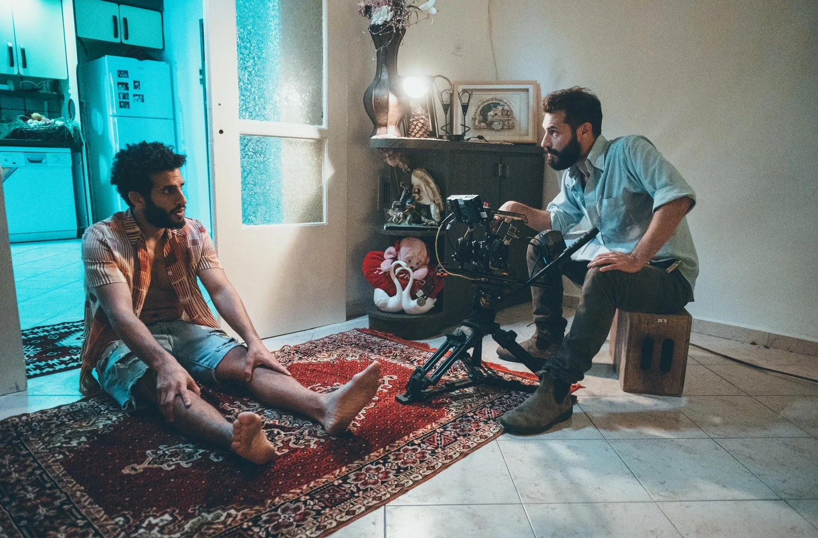 Two men on a film set in a living room, .  Bar Tzabari Music Video HADERA, Hadera Behind the seance, music video director 