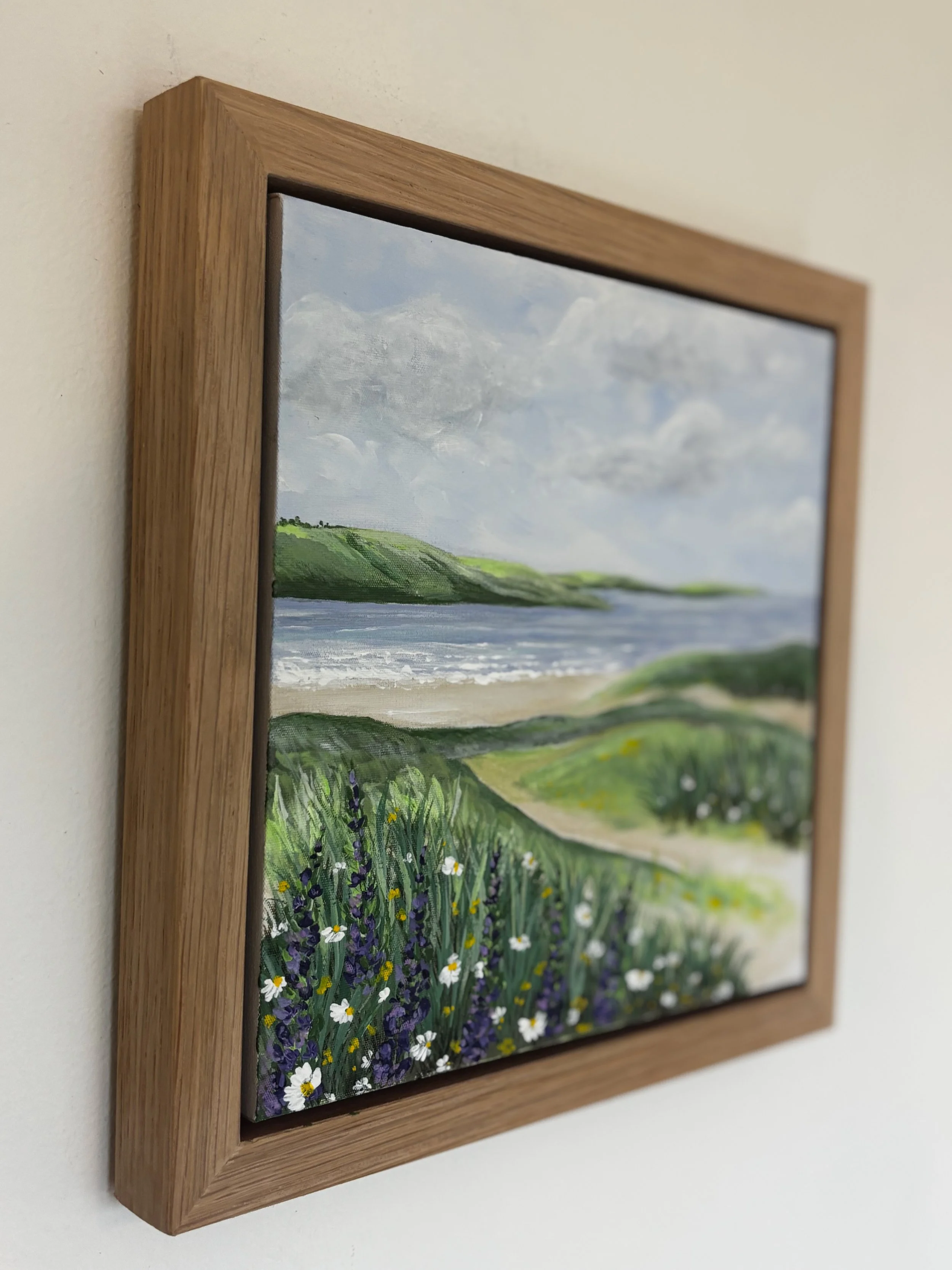 Rock to Tregirls original Cornwall coastal painting featuring green fields and calm estuary waters in oak veneer frame