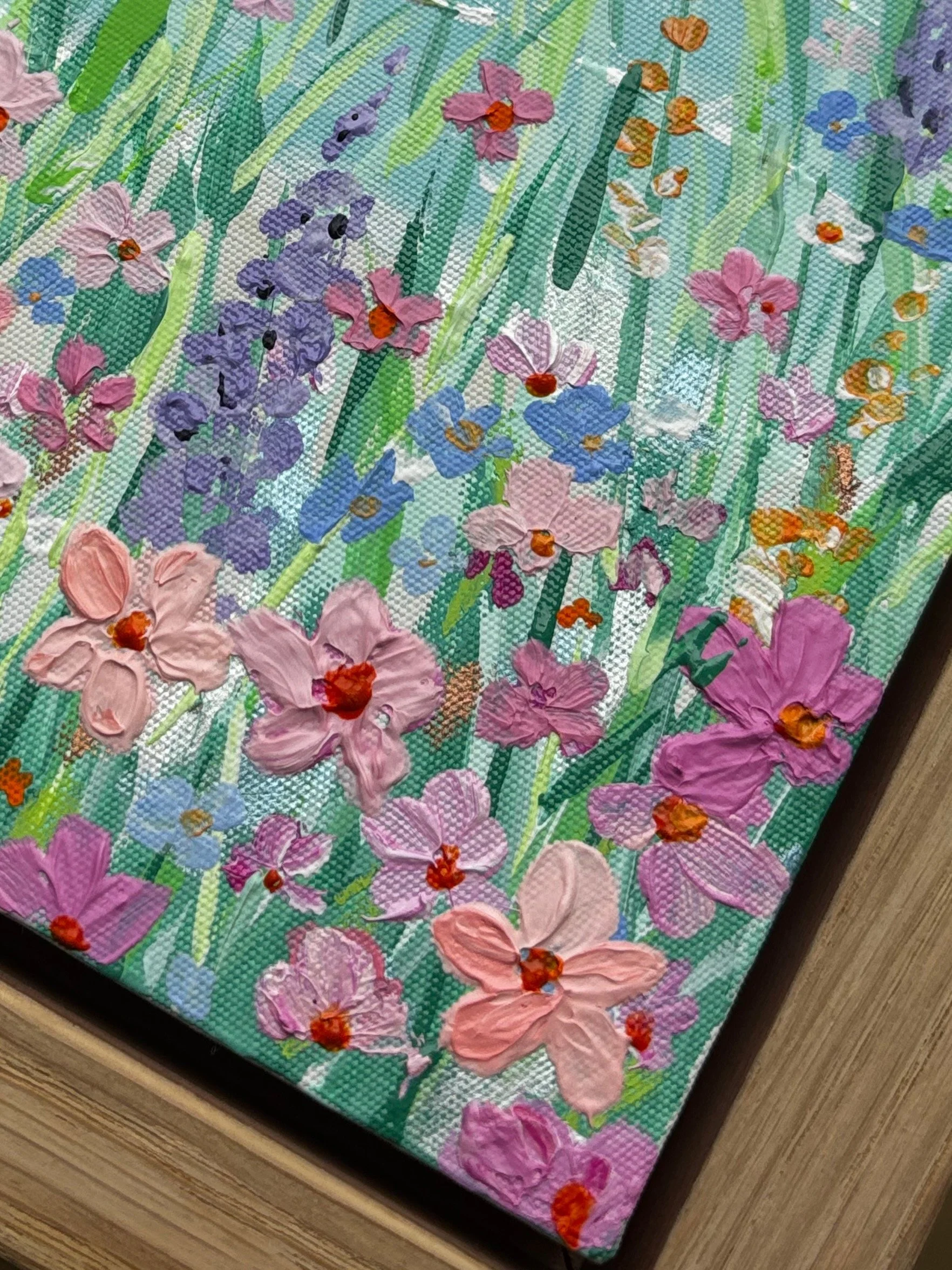 Seascape II original coastal landscape painting with pink skies turquoise ocean and meadow flowers in oak veneer frame