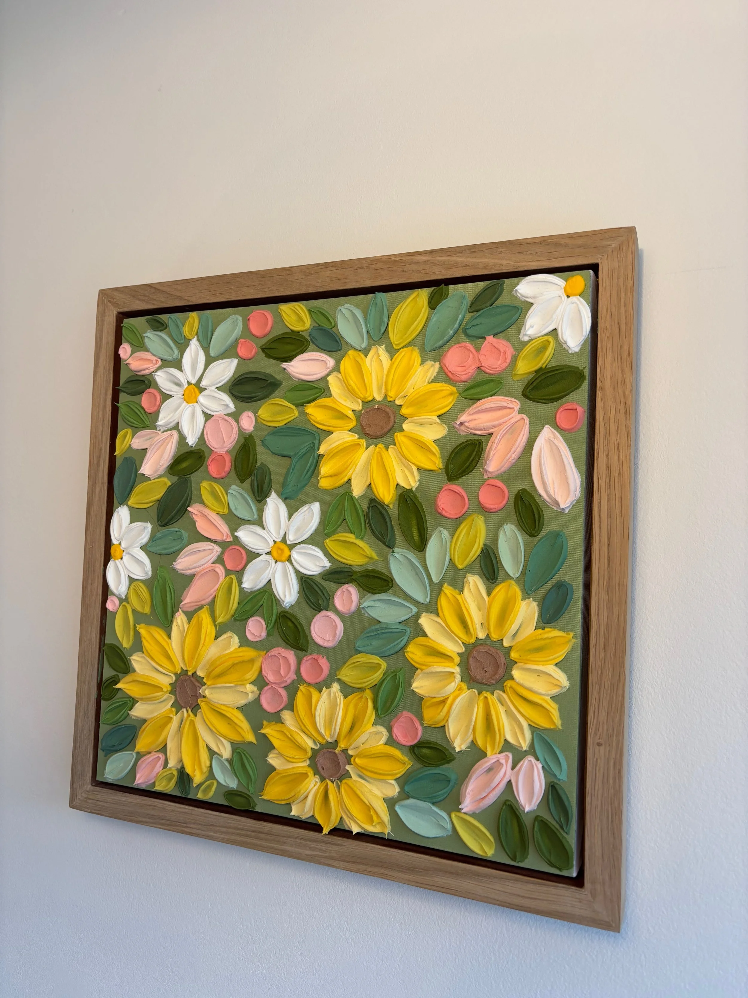 Textured floral wall art featuring large yellow sunflowers on olive green background