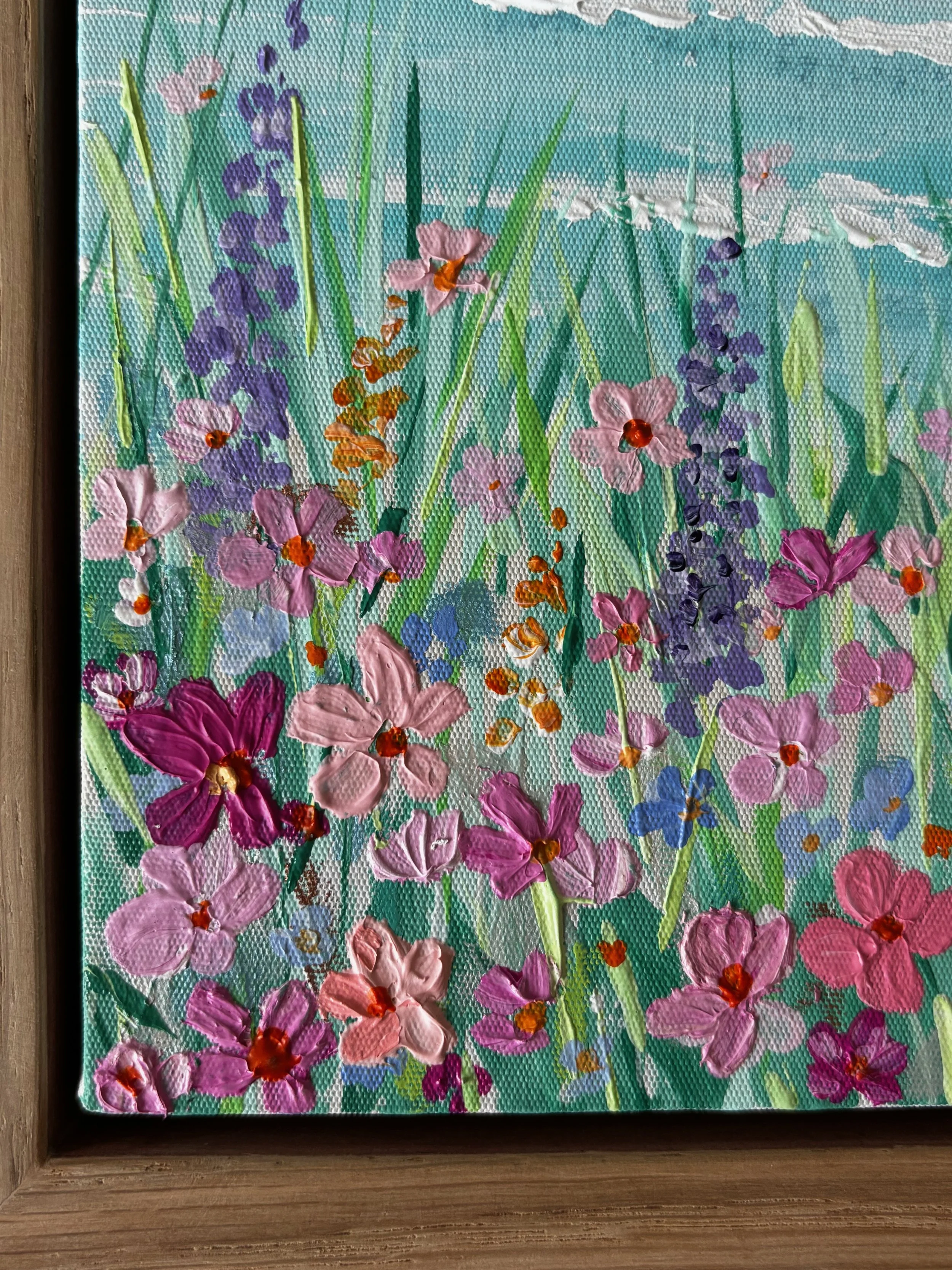 Seascape II original coastal landscape painting with pink skies turquoise ocean and meadow flowers in oak veneer frame