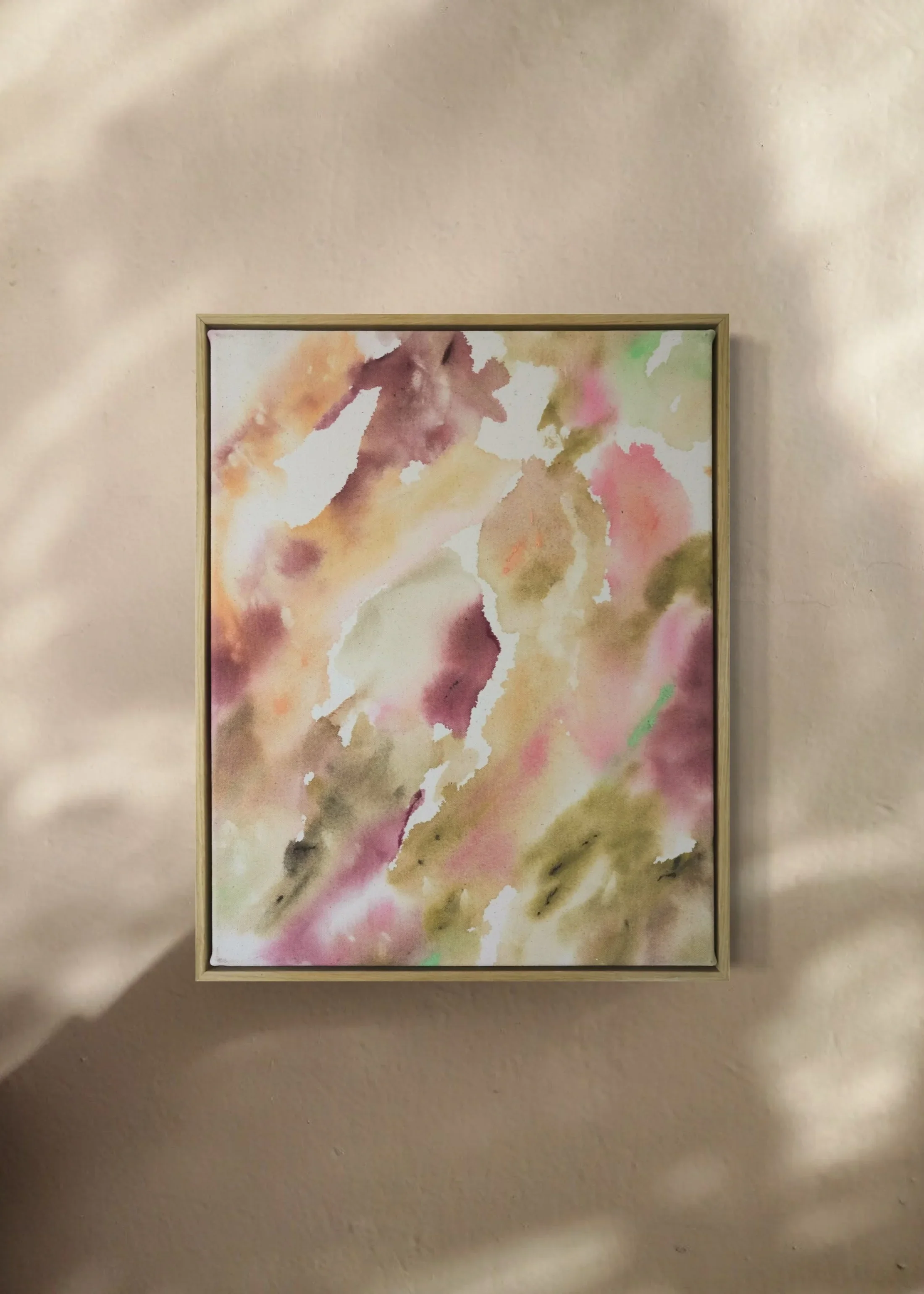 Watercolor painting with abstract soft pastel colors in a wooden frame.