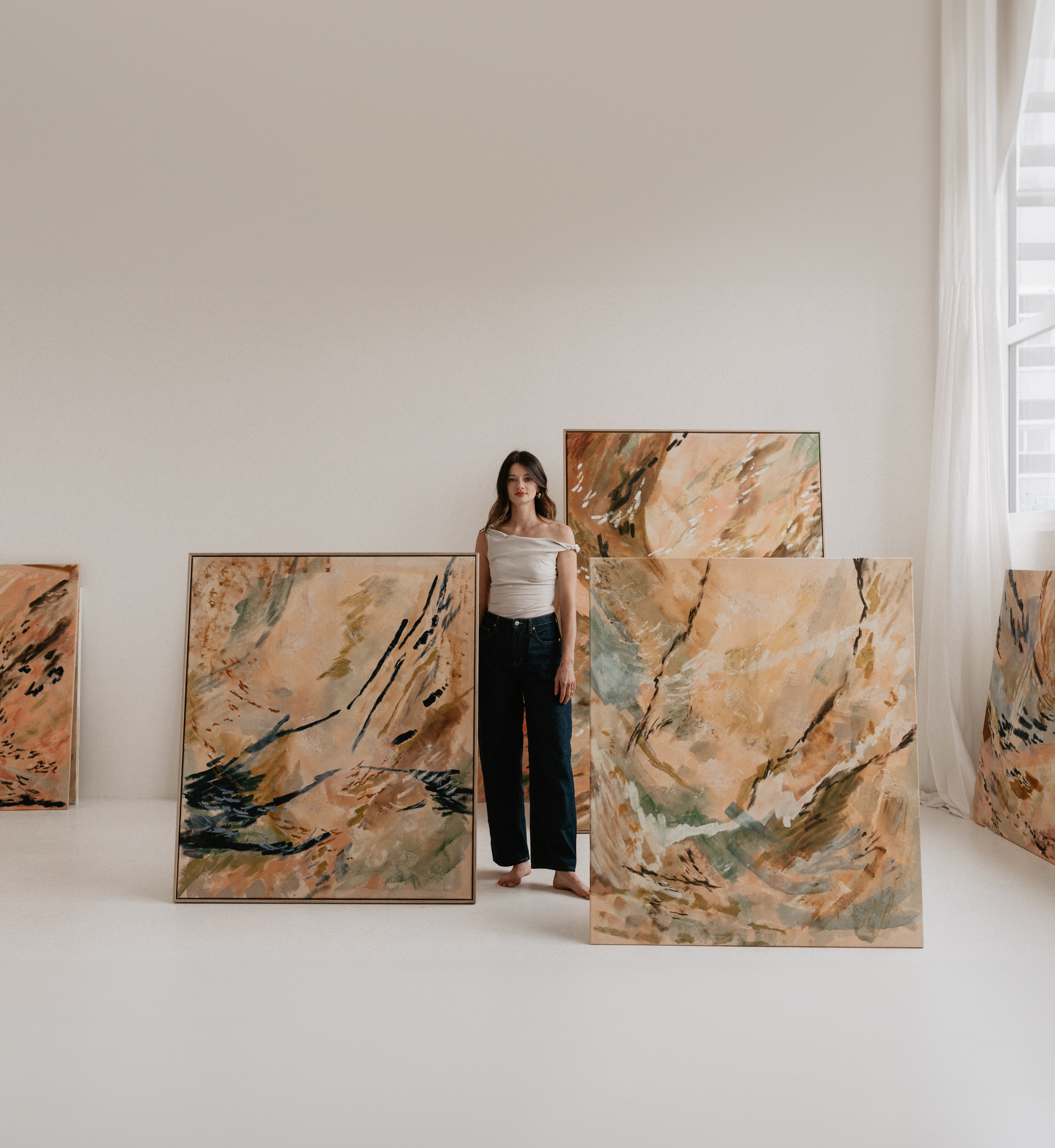Contemporary artist Christina Anna Sperber surrounded by her large-scale abstract original paintings in the studio.