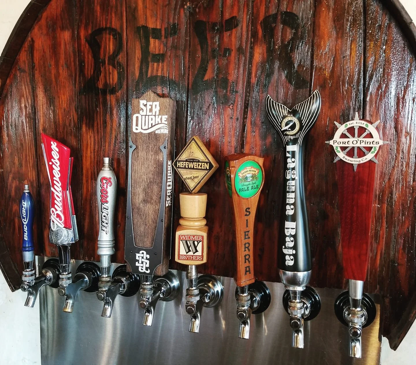 Bar with beer taps featuring various beer brands and custom tap handles.