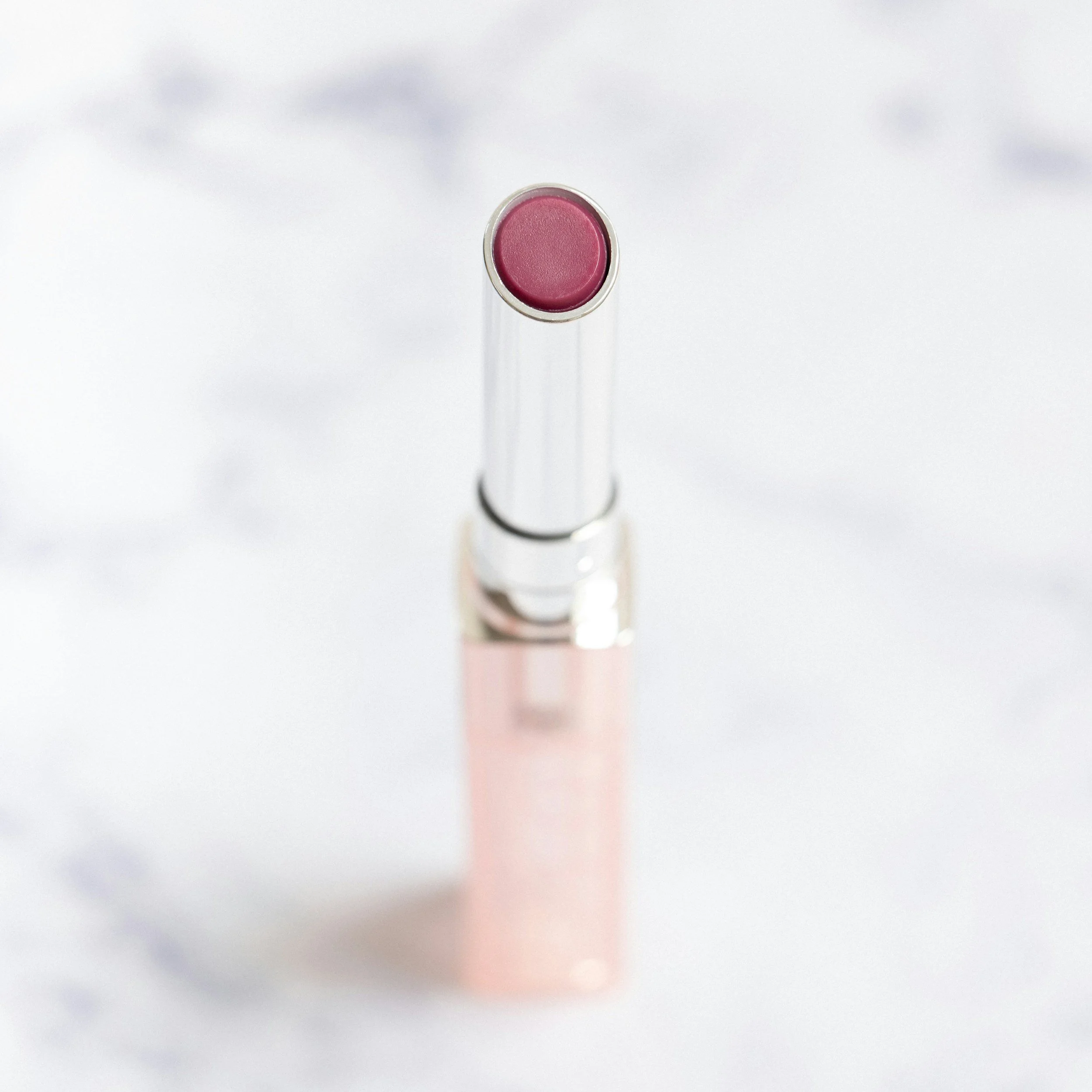 Close-up of a pink lipstick on a white surface