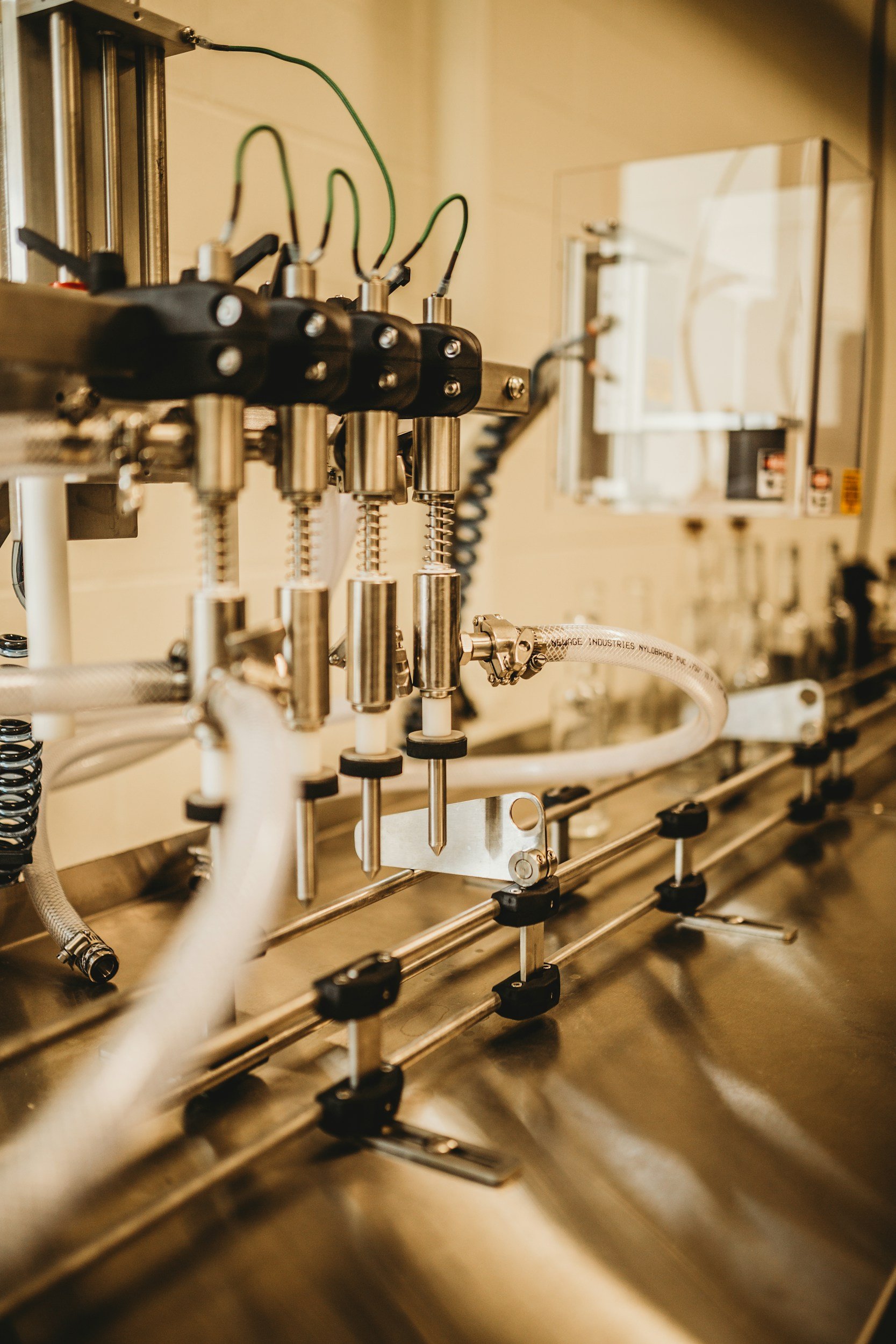 Close-up of metallic laboratory equipment with tubes, wires, and metal rods, likely used in scientific experiments.