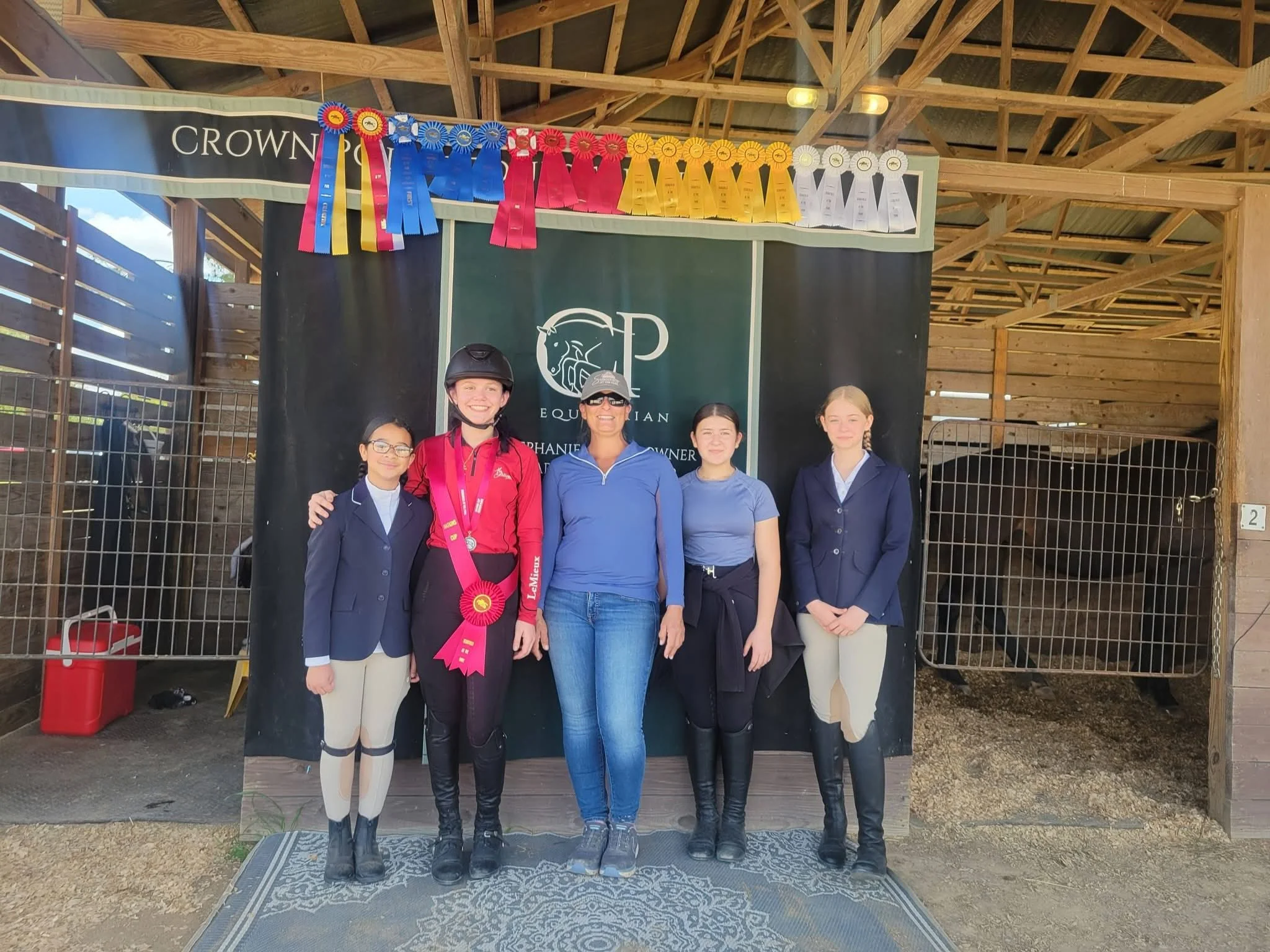 kids and trainer standing in front of show curtains and ribbons