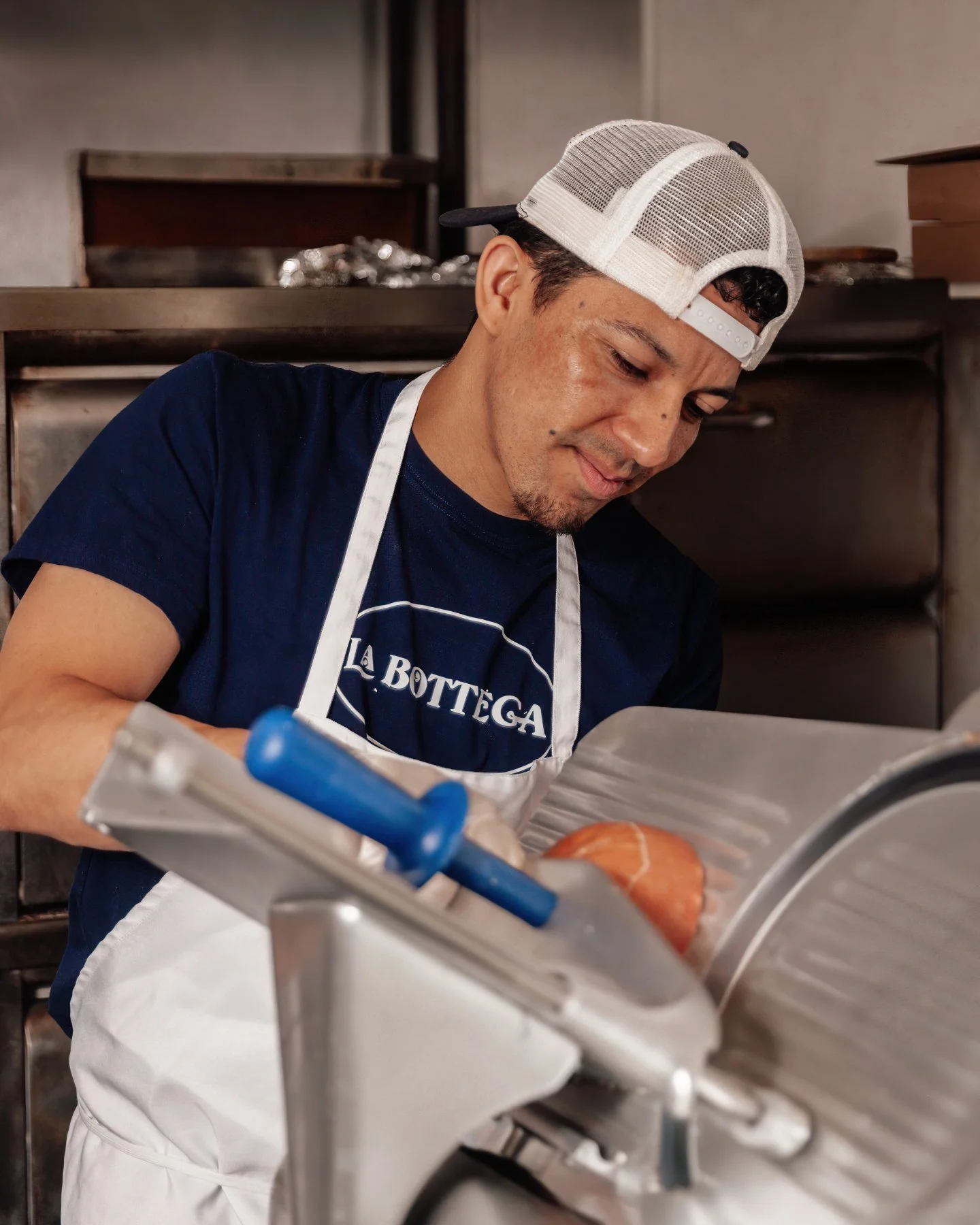 Behind every good panino is someone who knows the details matter.

Imported mortadella, sliced fresh, layered right, and ready for the press.