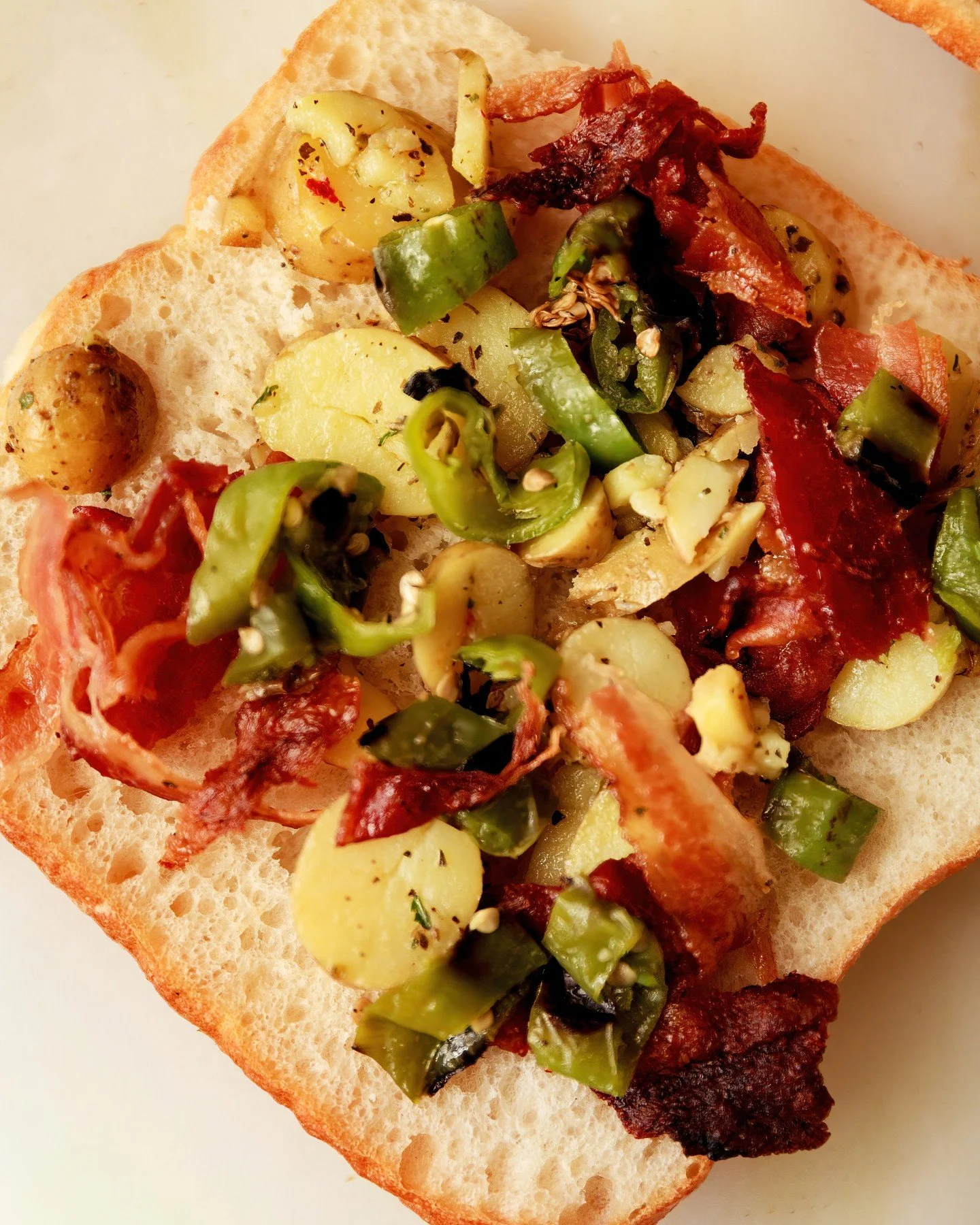 The Jordan, in the making.

Chicken cutlet, bacon, smoked mozzarella, marinated fingerling potatoes, hot peppers, iceberg, tomato and mustard sauce on ciabatta.

A lot going on. Exactly the point.
Order now at lborder.com