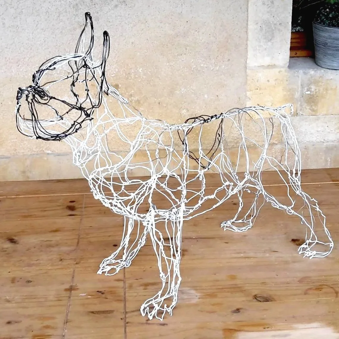 Sculpture d'un chien bouledogue en fil de fer noir et blanc