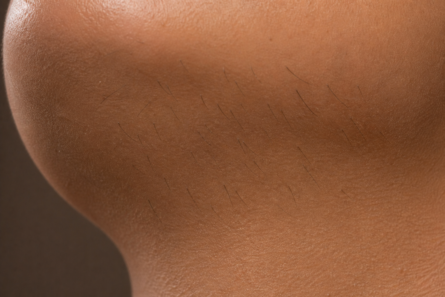 Close-up of a person's body with patches of shaved hair and skin.