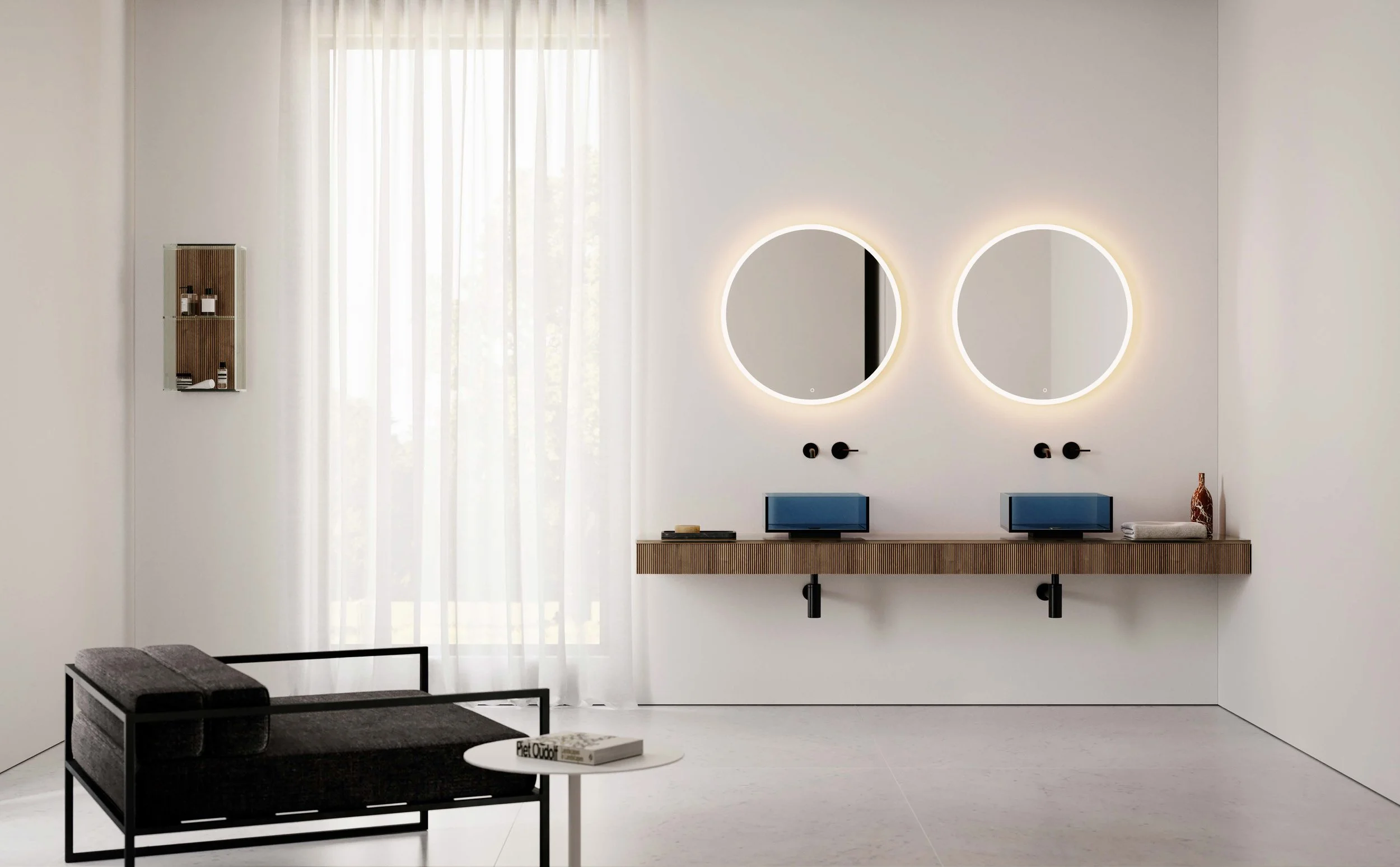 Modern bathroom with two round illuminated mirrors above a floating wooden vanity, two small computer screens, a minimalist design, sheer white curtains, and a gray bench in the foreground.