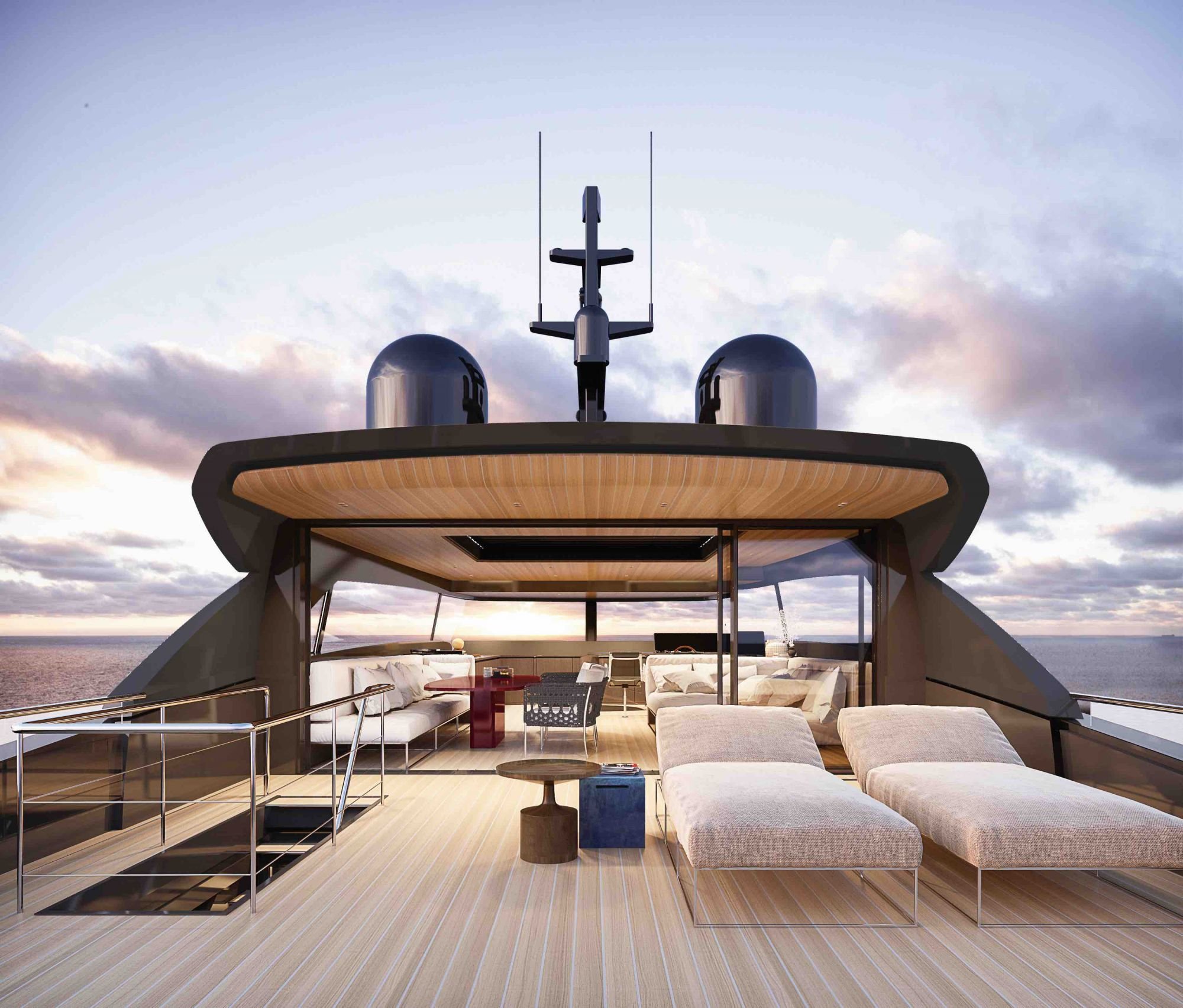 Luxury yacht's outdoor lounge area with sectional sofa, coffee table, and a view of the ocean at sunset.