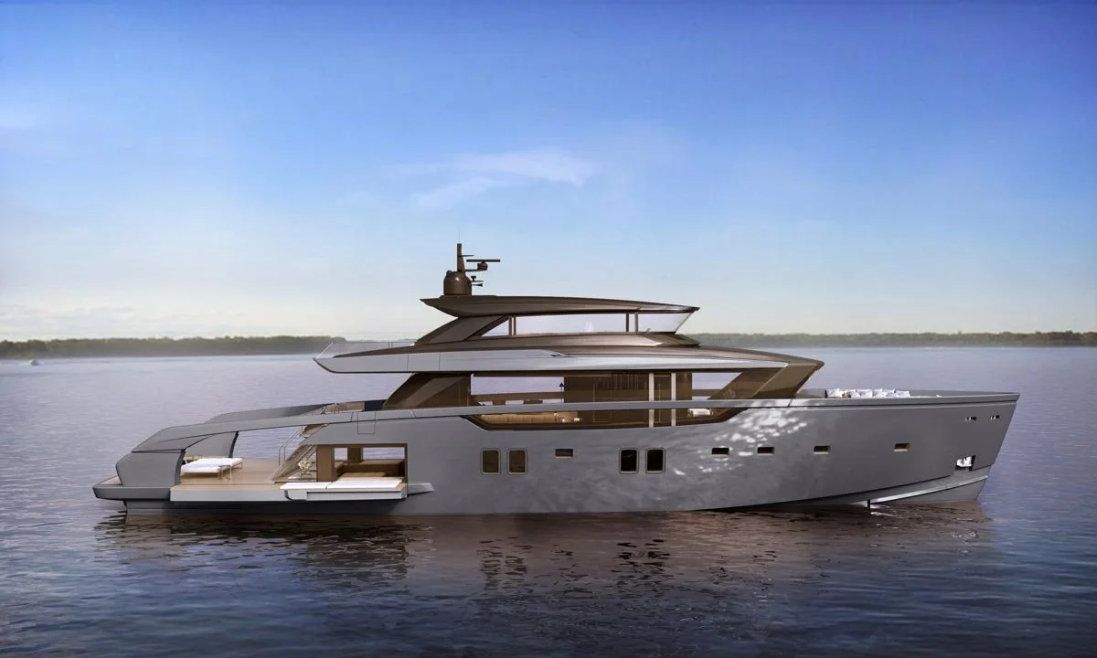 A modern luxury yacht floating on calm water with a clear sky in the background.