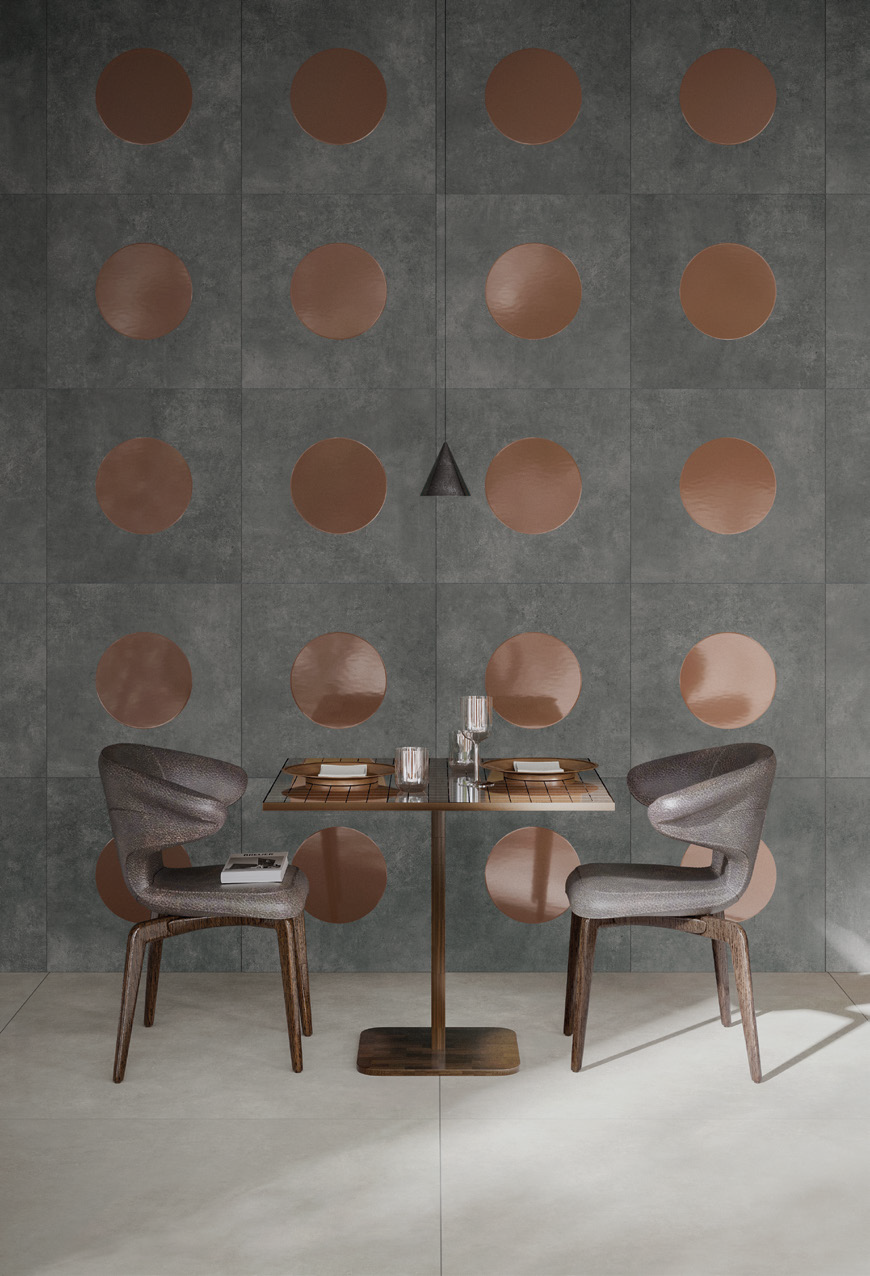 A small dining table set with two chairs and tableware in front of a wall decorated with circular copper-colored accents.