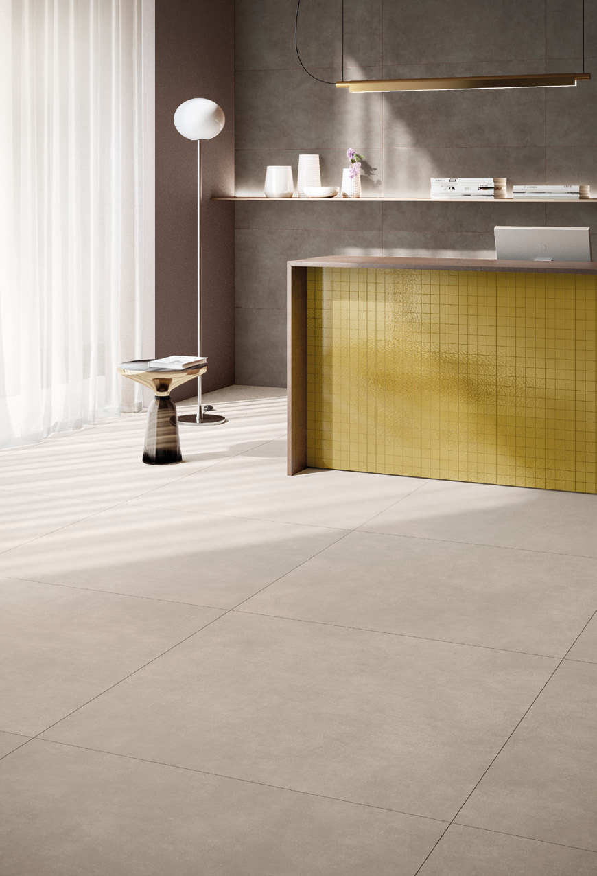 Modern interior with a reception desk, a tall floor lamp, a small side table, and minimalist decor featuring neutral tones and soft natural light.
