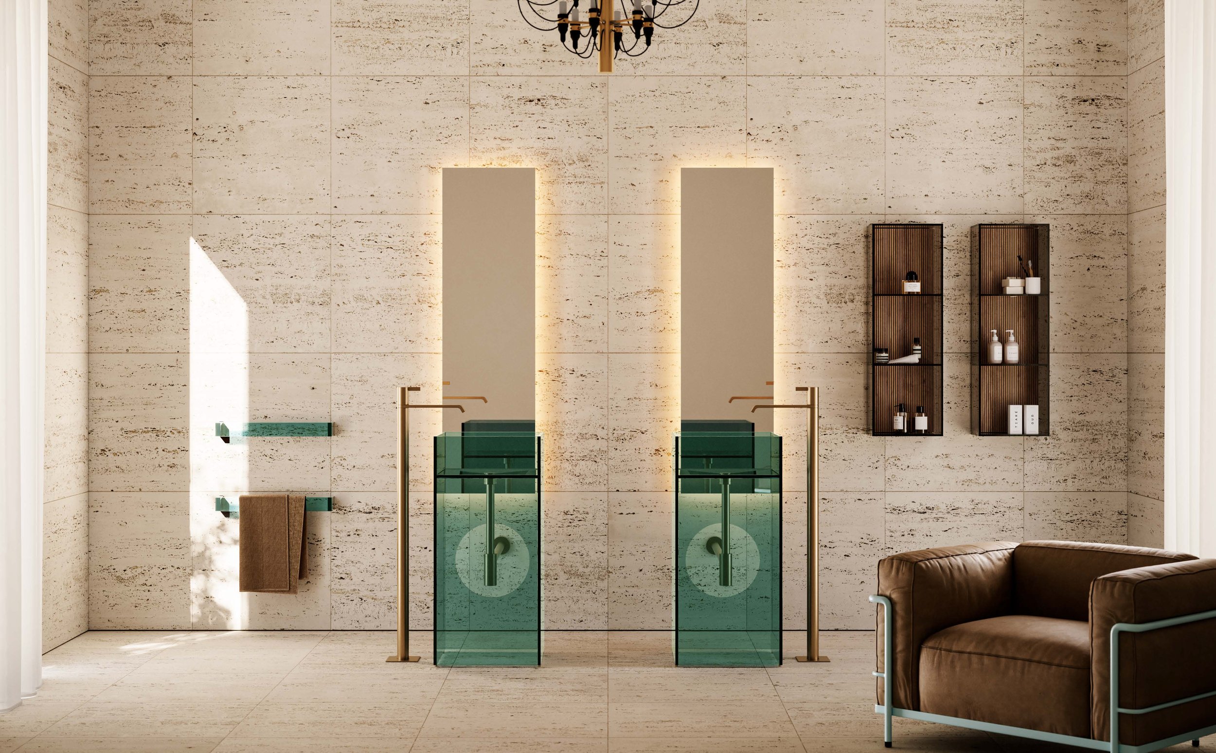 Modern bathroom with beige tiled walls, two green glass sinks with gold faucets, wall-mounted shelves, and a brown leather sofa on the right.