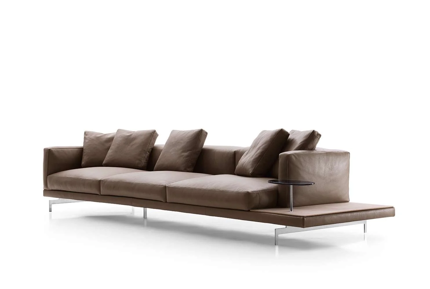 Modern beige sofa with three cushions and a small side table.