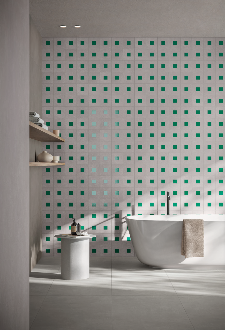 Modern bathroom with a freestanding bathtub, a hanging towel, two wooden shelves with towels and decor, and a backsplash of square tiles with green accents.